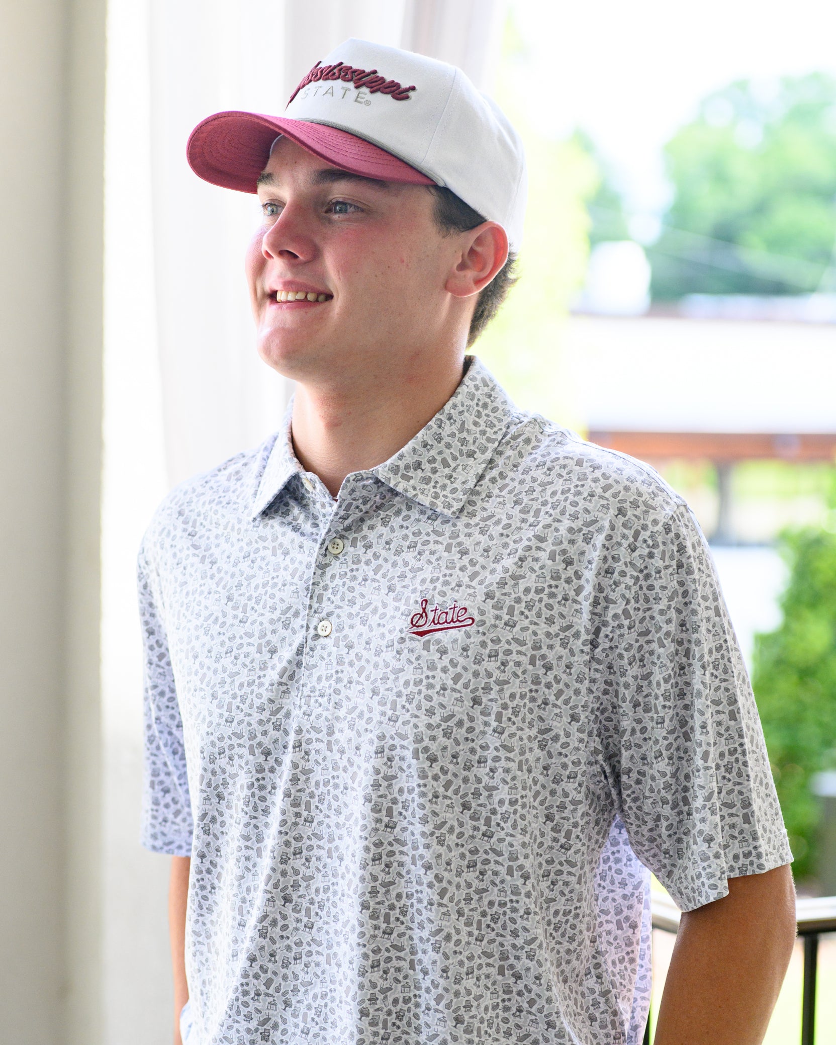 Mississippi State Grey Men’s Patterned Polo with a tailgate themed pattern and the Script State Logo embroidery
