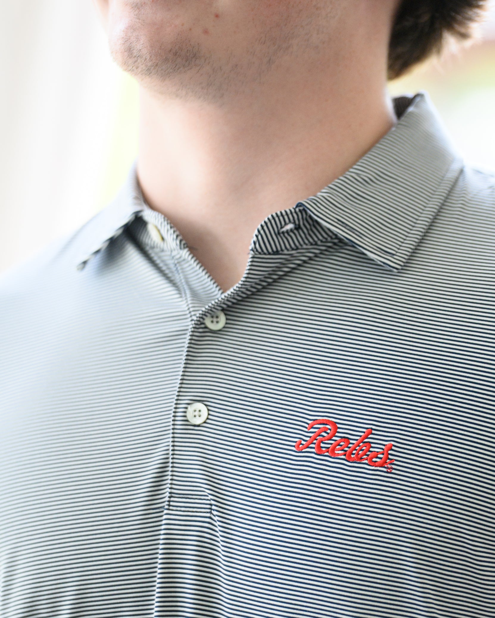 Ole Miss Navy Men’s Stripe Polo with the Script Rebs Logo embroidery