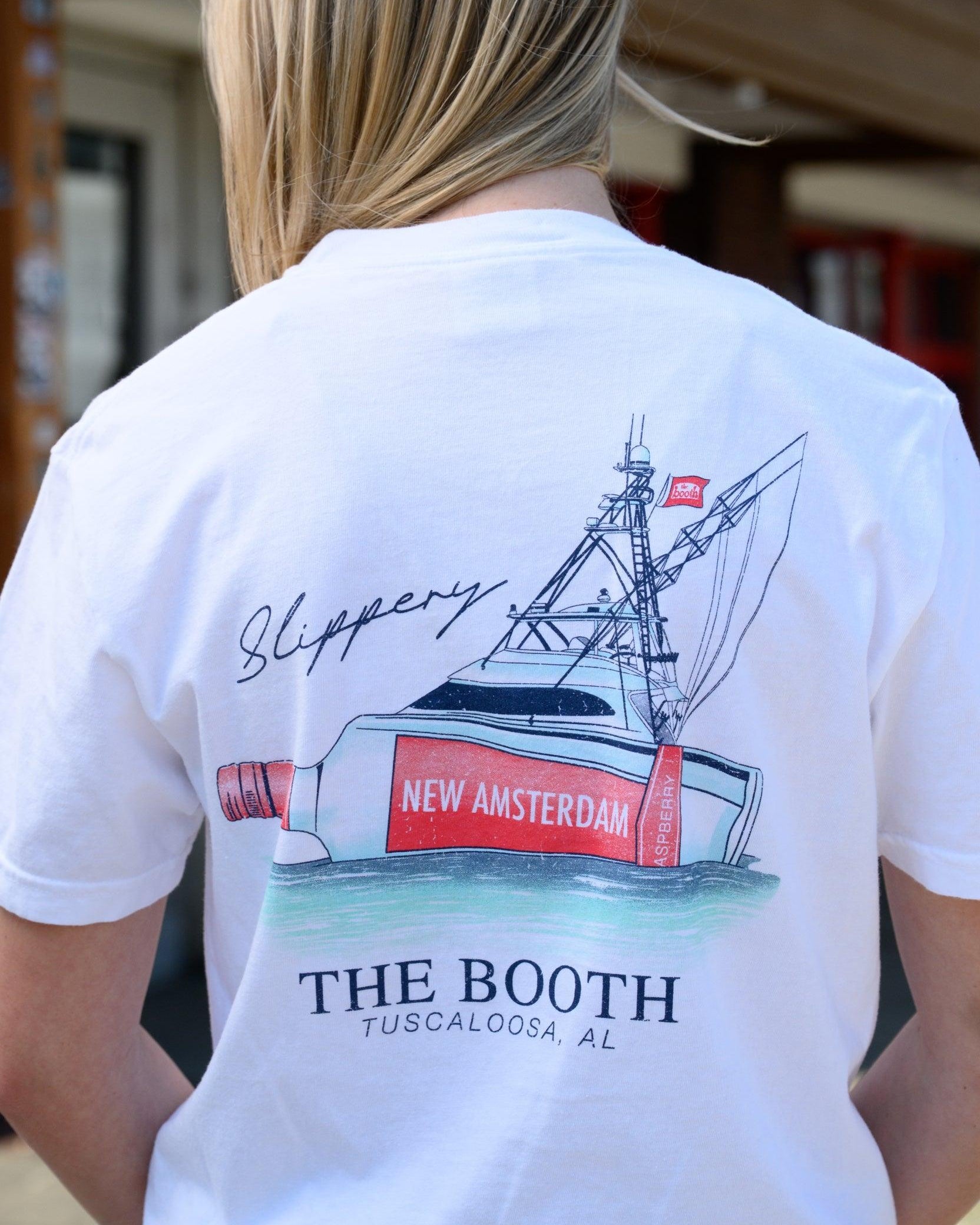 The Booth White T-Shirt featuring an illustration of a bottle attached to a boat next to script text “Slippery”
