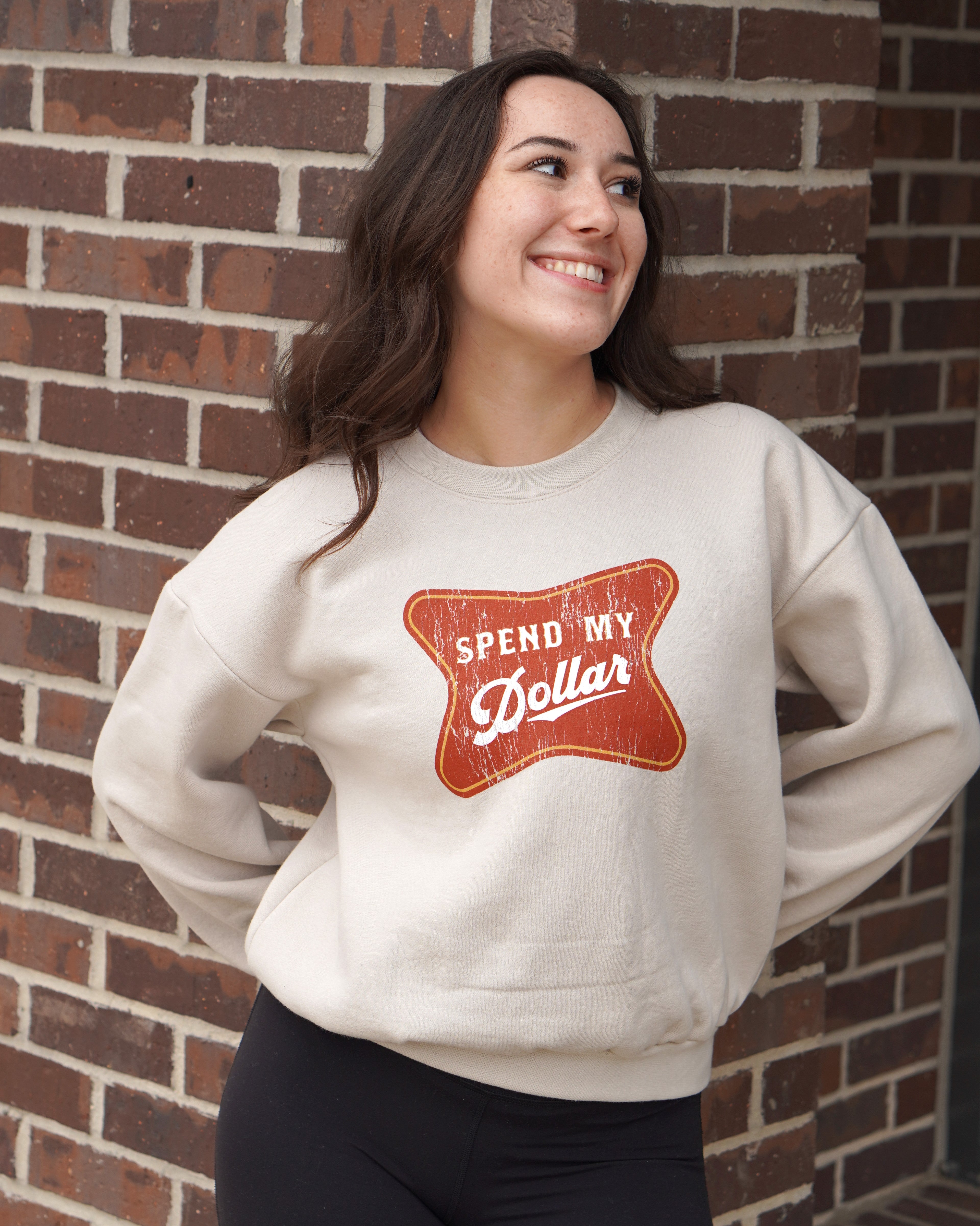 University of Alabama Bone Ladies' Crewneck featuring a Red sign with White text "Spend My Dollar"