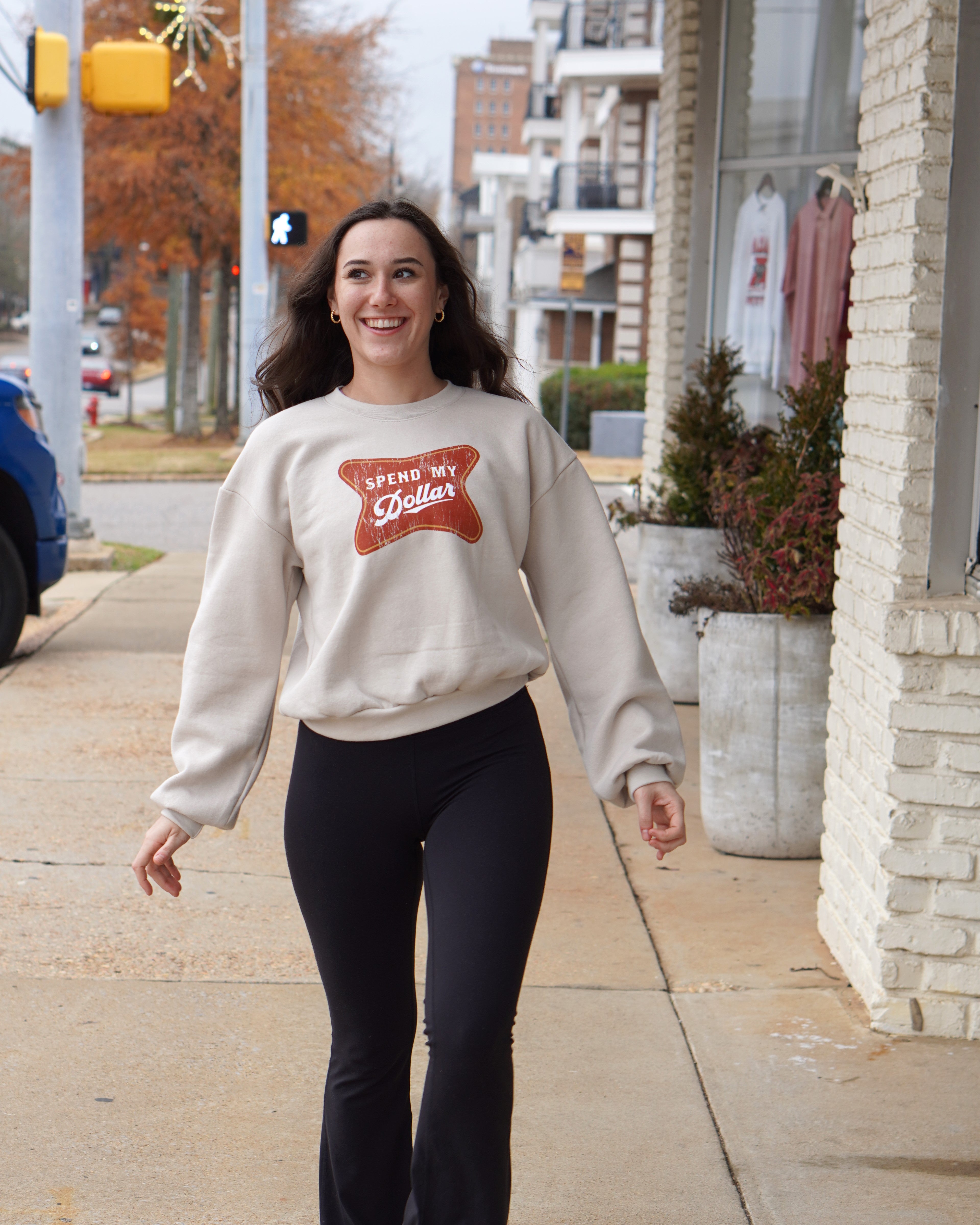 University of Alabama Bone Ladies' Crewneck featuring a Red sign with White text "Spend My Dollar"