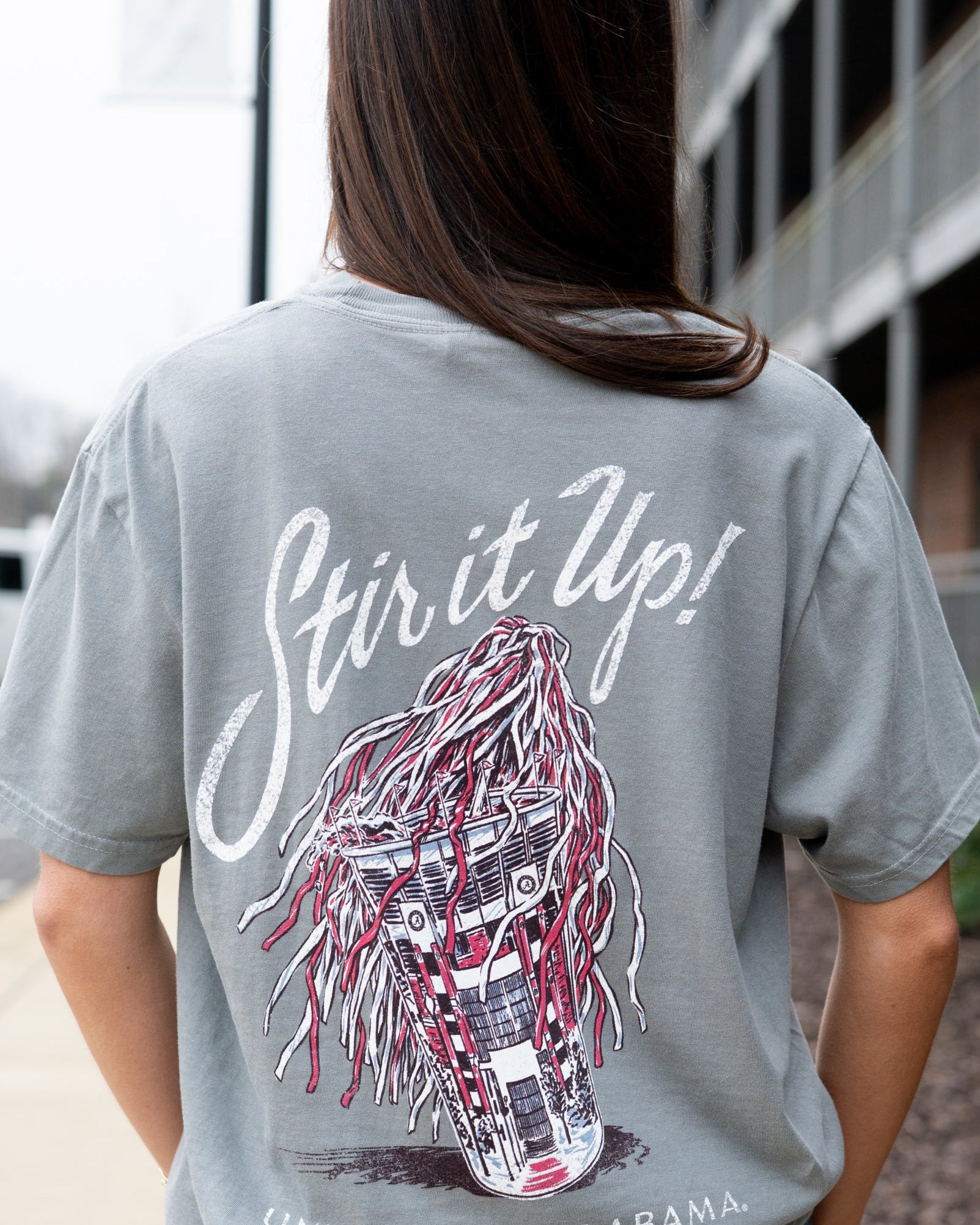 University of Alabama Grey T-Shirt with White text “Stir it Up!” above a stadium cup with a Red and White shaker inside