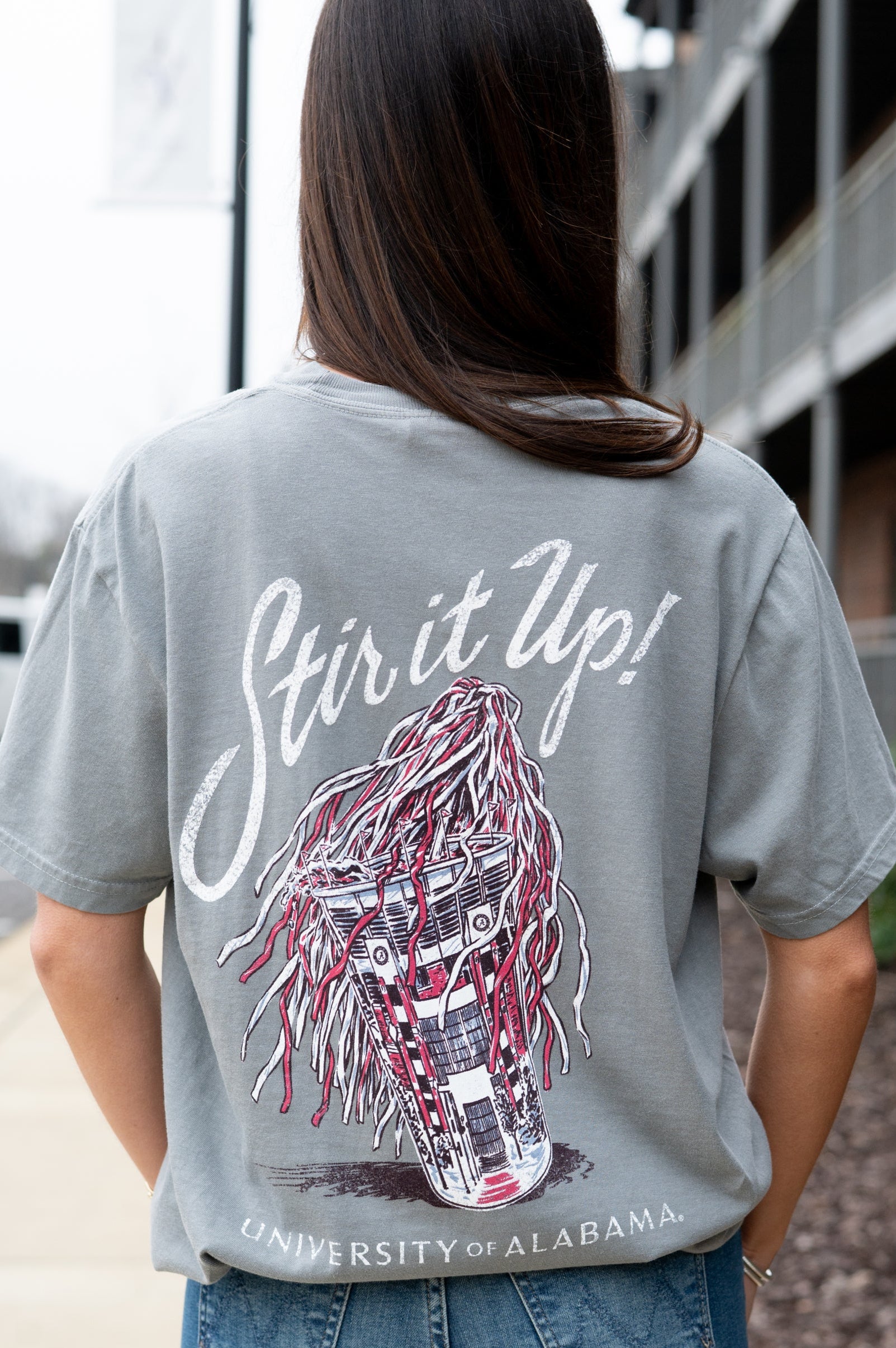 University of Alabama Grey T-Shirt with White text “Stir it Up!” above a stadium cup with a Red and White shaker inside