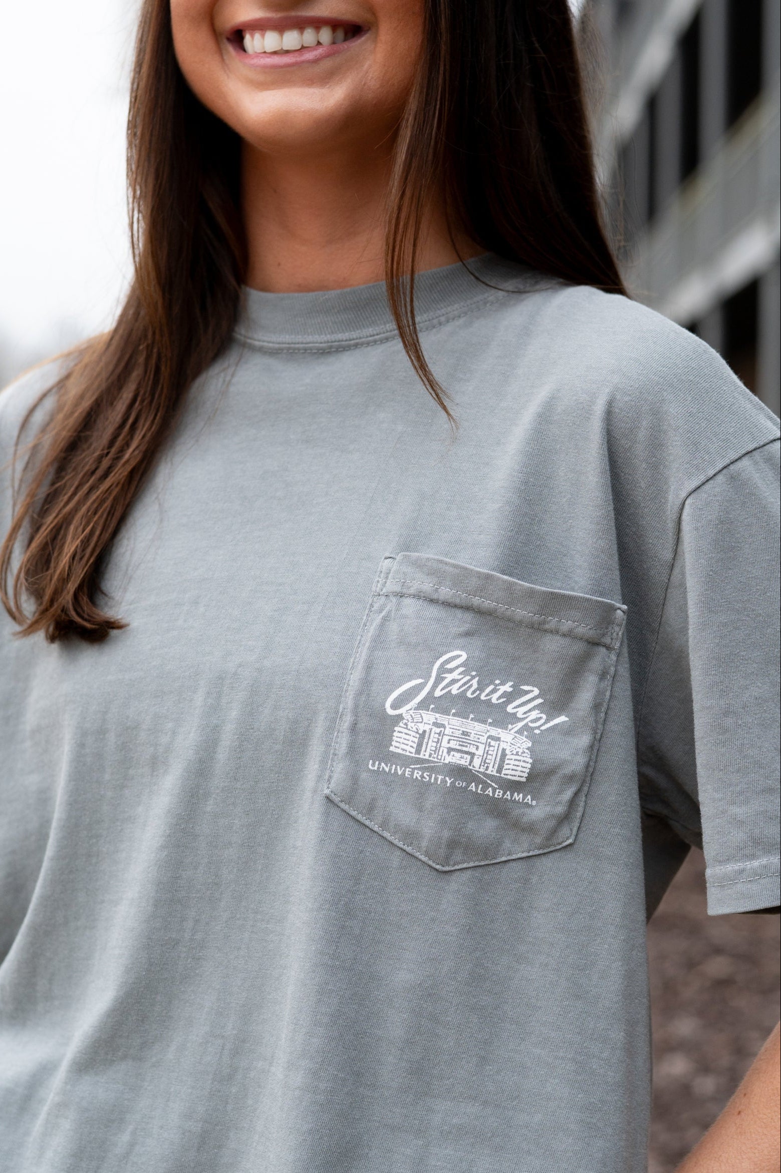 University of Alabama Grey T-Shirt Pocket Design with White text “stir it up” over the Bryant-Denny Stadium