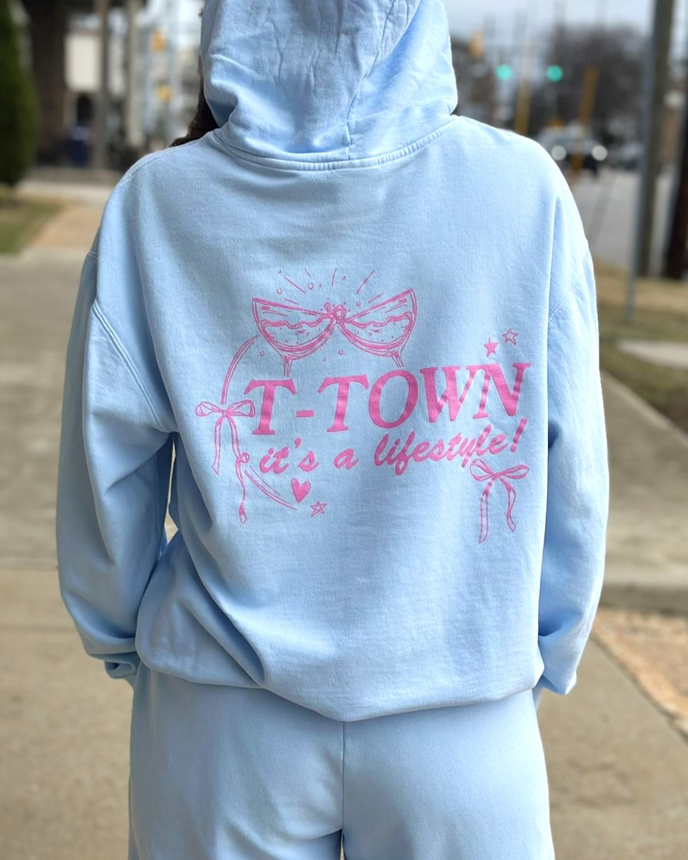 Light Blue T-Town Lifestyle Ladies' Hoodie with Pink bows hearts, and stars surrounding Pink text "T-TOWN it's a lifestyle!"
