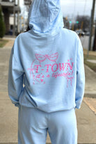 Light Blue T-Town Lifestyle Ladies' Hoodie with Pink bows hearts, and stars surrounding Pink text "T-TOWN it's a lifestyle!"