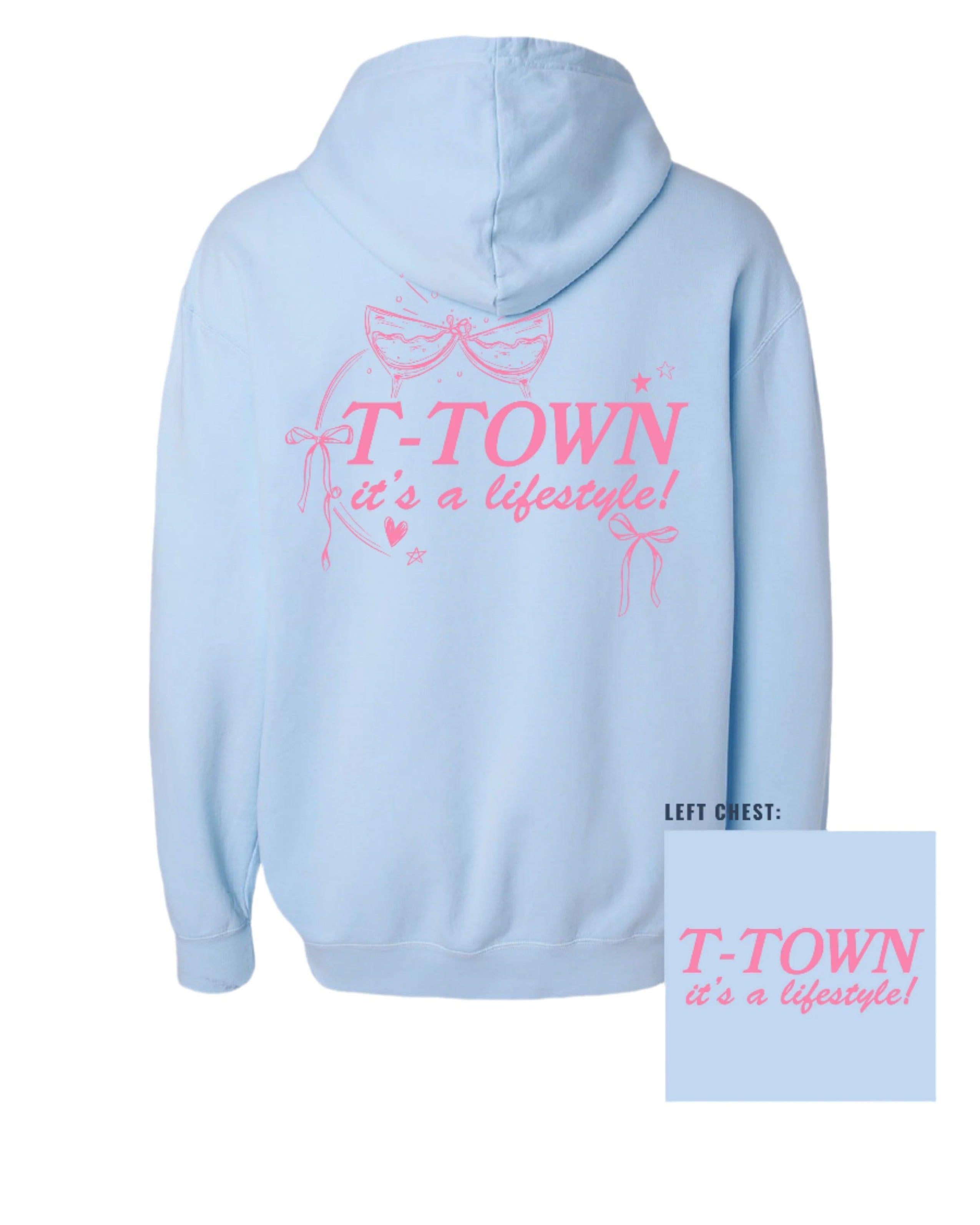 Light Blue T-Town Lifestyle Ladies' Hoodie with Pink bows hearts, and stars surrounding Pink text "T-TOWN it's a lifestyle!"