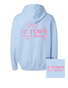 Light Blue T-Town Lifestyle Ladies' Hoodie with Pink bows hearts, and stars surrounding Pink text "T-TOWN it's a lifestyle!"