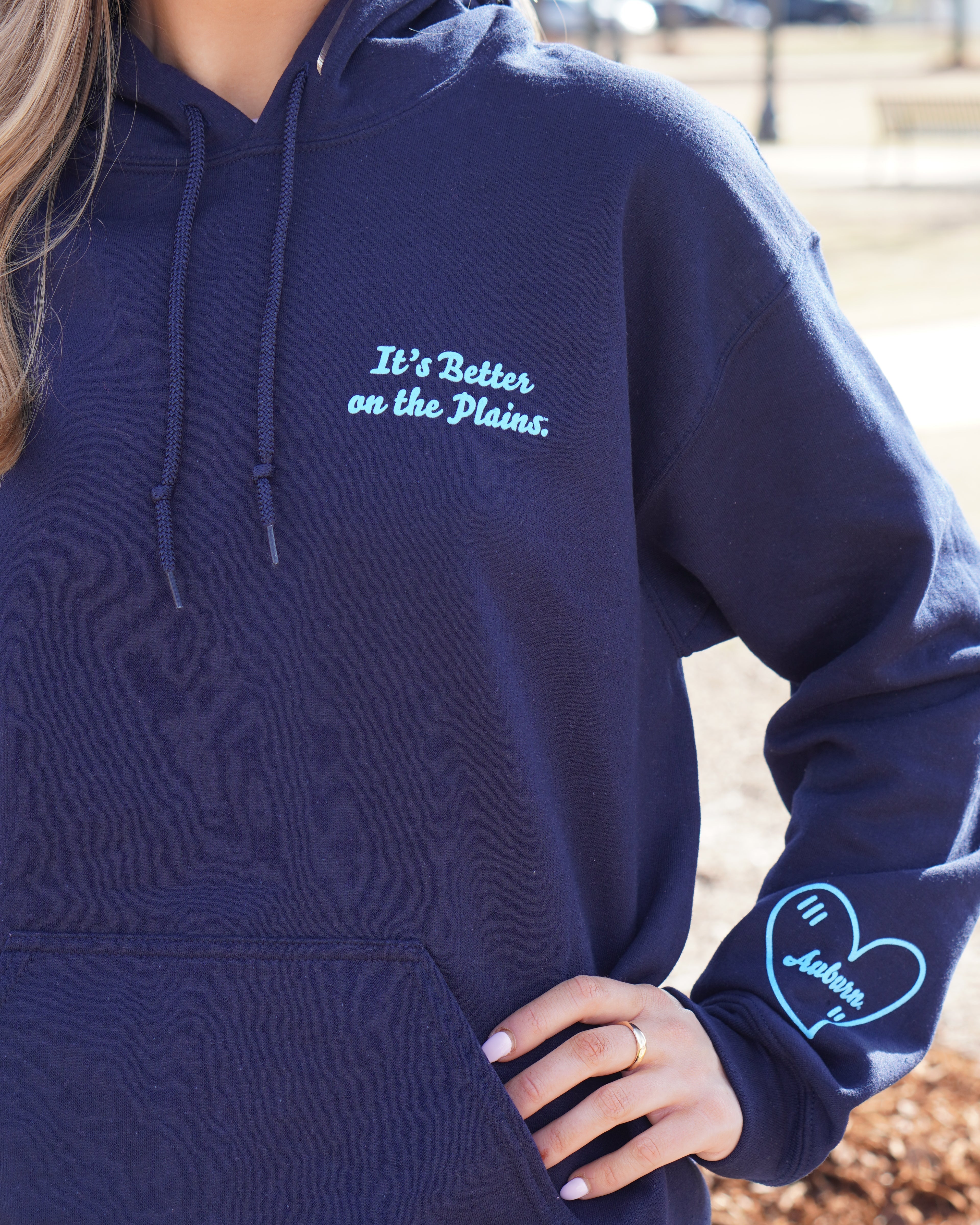 Auburn University Navy Ladies Hoodie with Light Blue text "It's Better on the Plains." (FRONT) | Light Blue heart with text "Auburn" inside (SLEEVE)