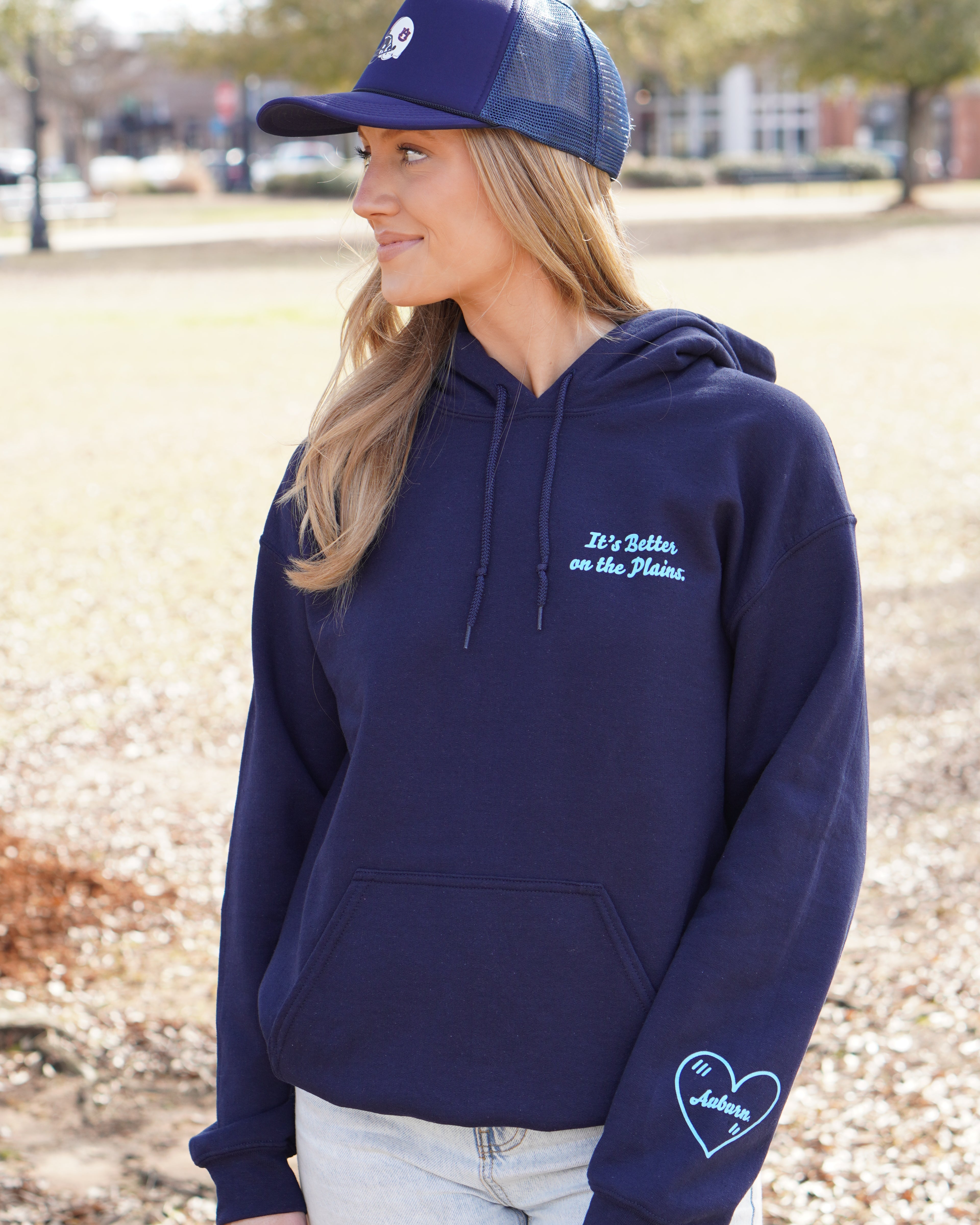Auburn University Navy Ladies Hoodie with Light Blue text "It's Better on the Plains." (FRONT) | Light Blue heart with text "Auburn" inside (SLEEVE)