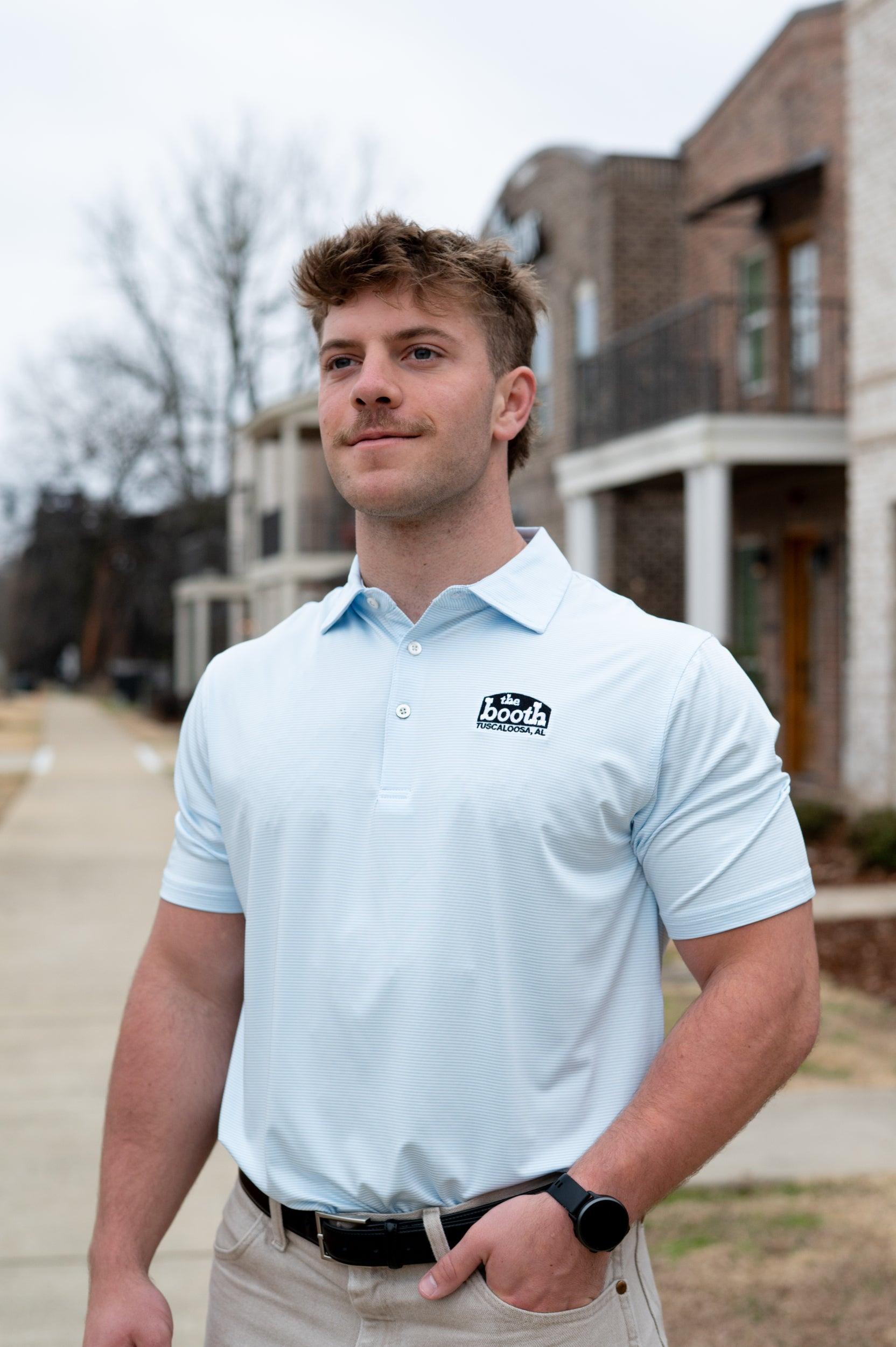 The Booth Light Blue Stripe Men’s Polo with The Booth Logo embroidered on the chest
