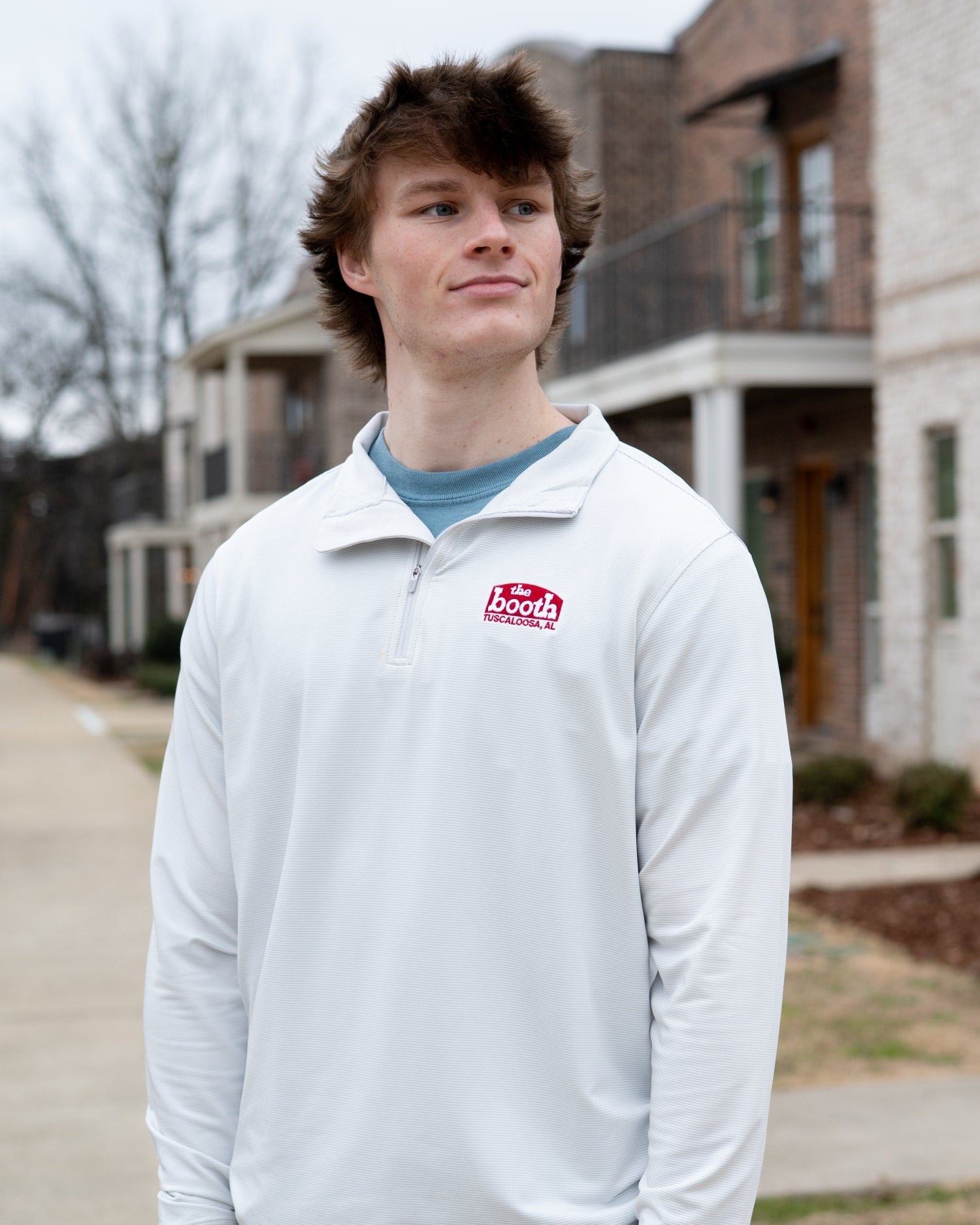 The Booth Light Blue Stripe Men’s Pullover with a Red The Booth Logo embroidered on the chest