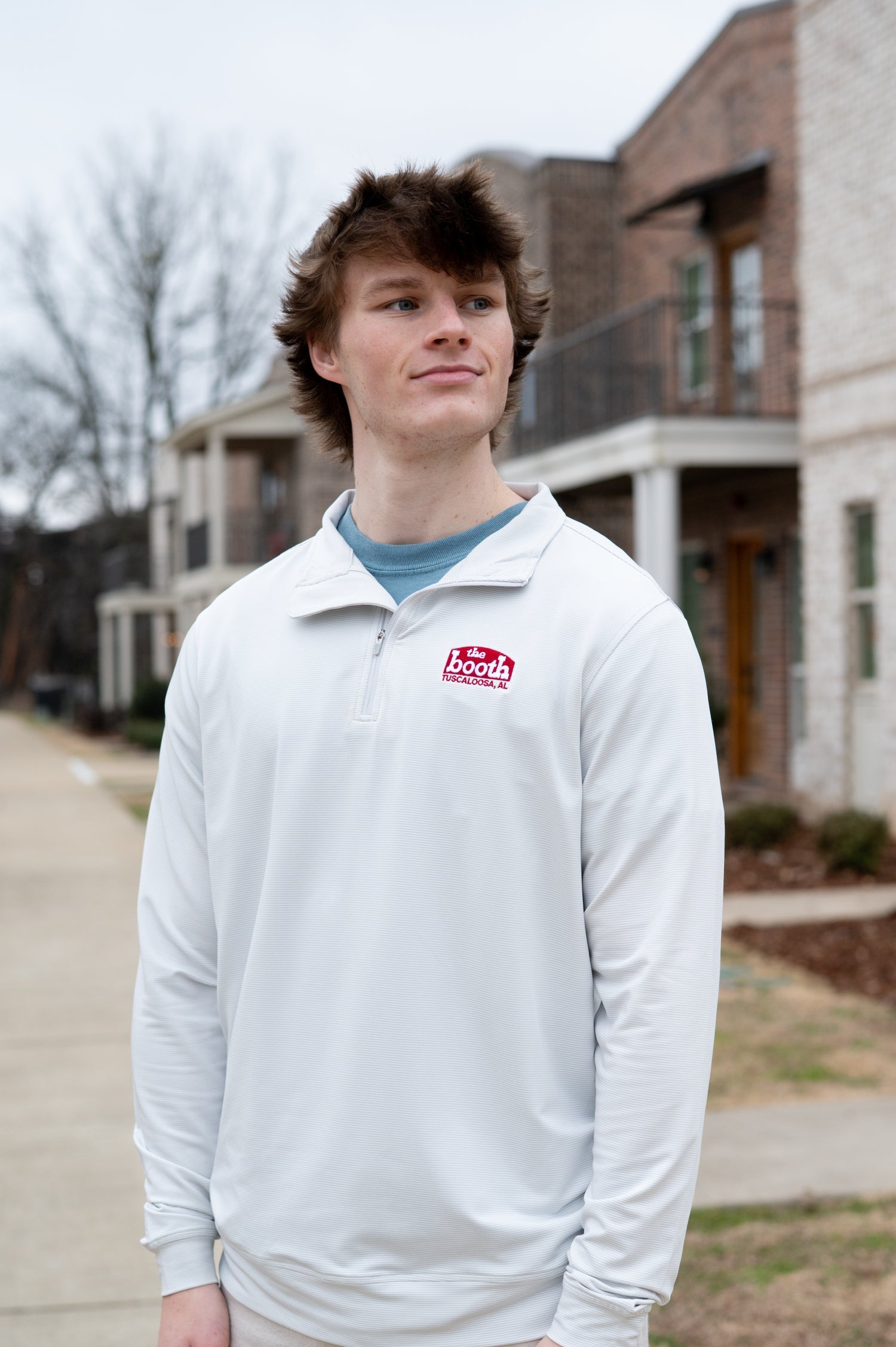 The Booth Light Blue Stripe Men’s Pullover with a Red The Booth Logo embroidered on the chest