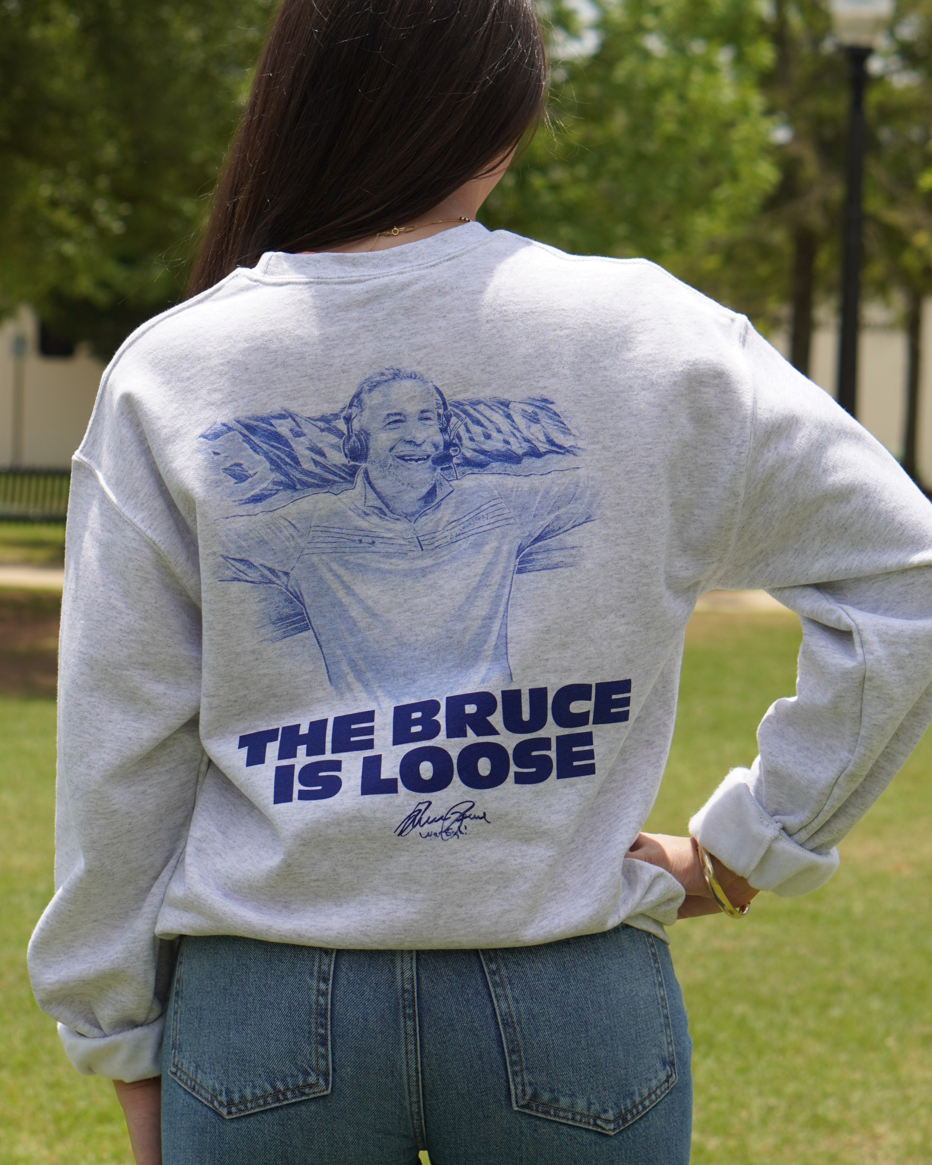 Auburn University Light Grey The Bruce is Loose Sweatshirt featuring an illustration of the Auburn Basketball coach above text "The Bruce is Loose"