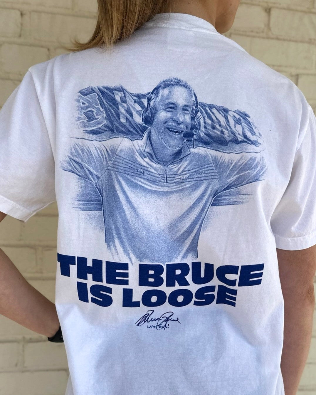 Auburn University White The Bruce is Loose T-Shirt featuring an illustration of the Auburn Basketball coach above text "The Bruce is Loose"