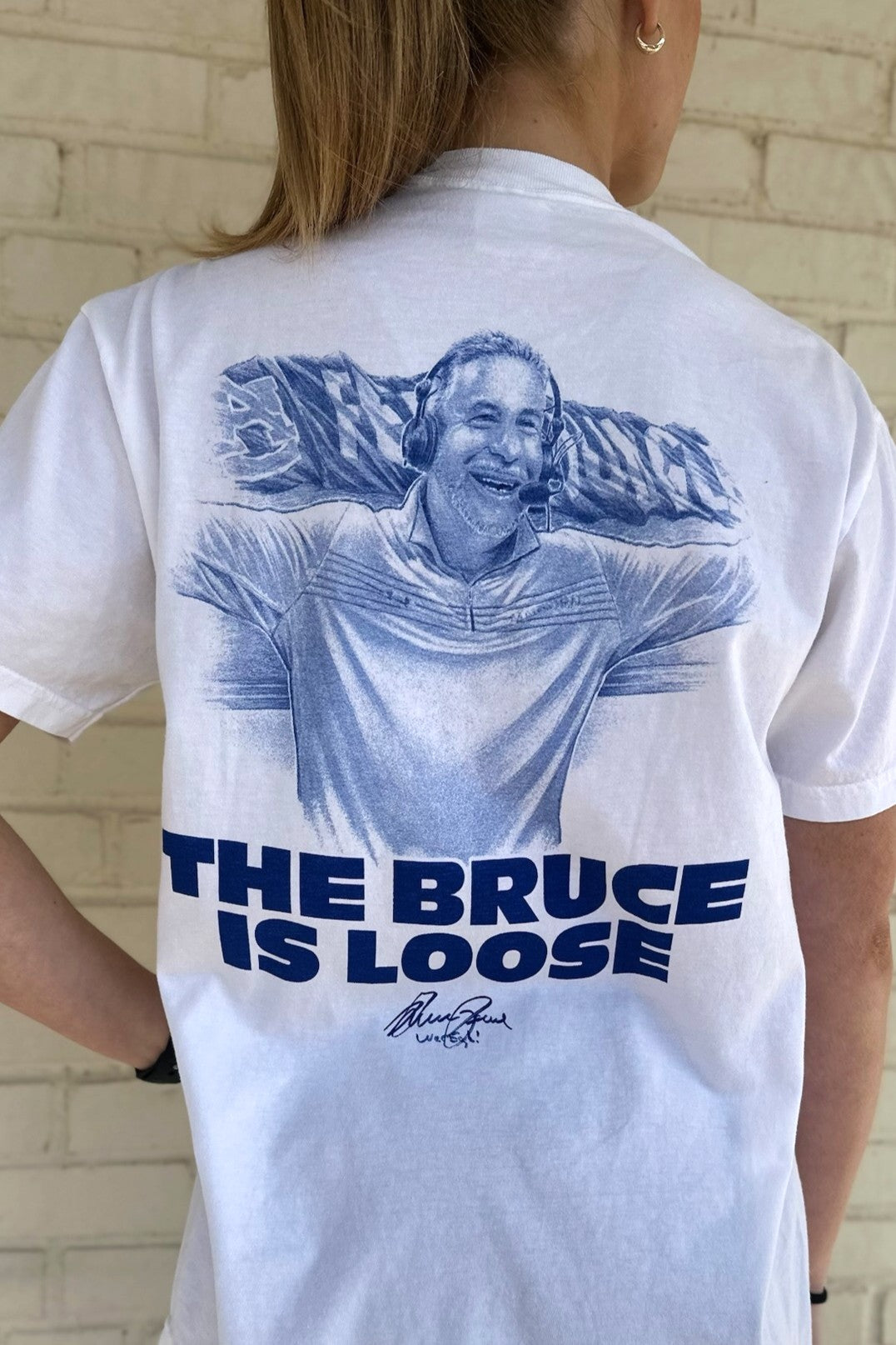 Auburn University White The Bruce is Loose T-Shirt featuring an illustration of the Auburn Basketball coach above text "The Bruce is Loose"