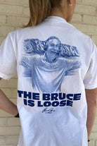 Auburn University White The Bruce is Loose T-Shirt featuring an illustration of the Auburn Basketball coach above text "The Bruce is Loose"