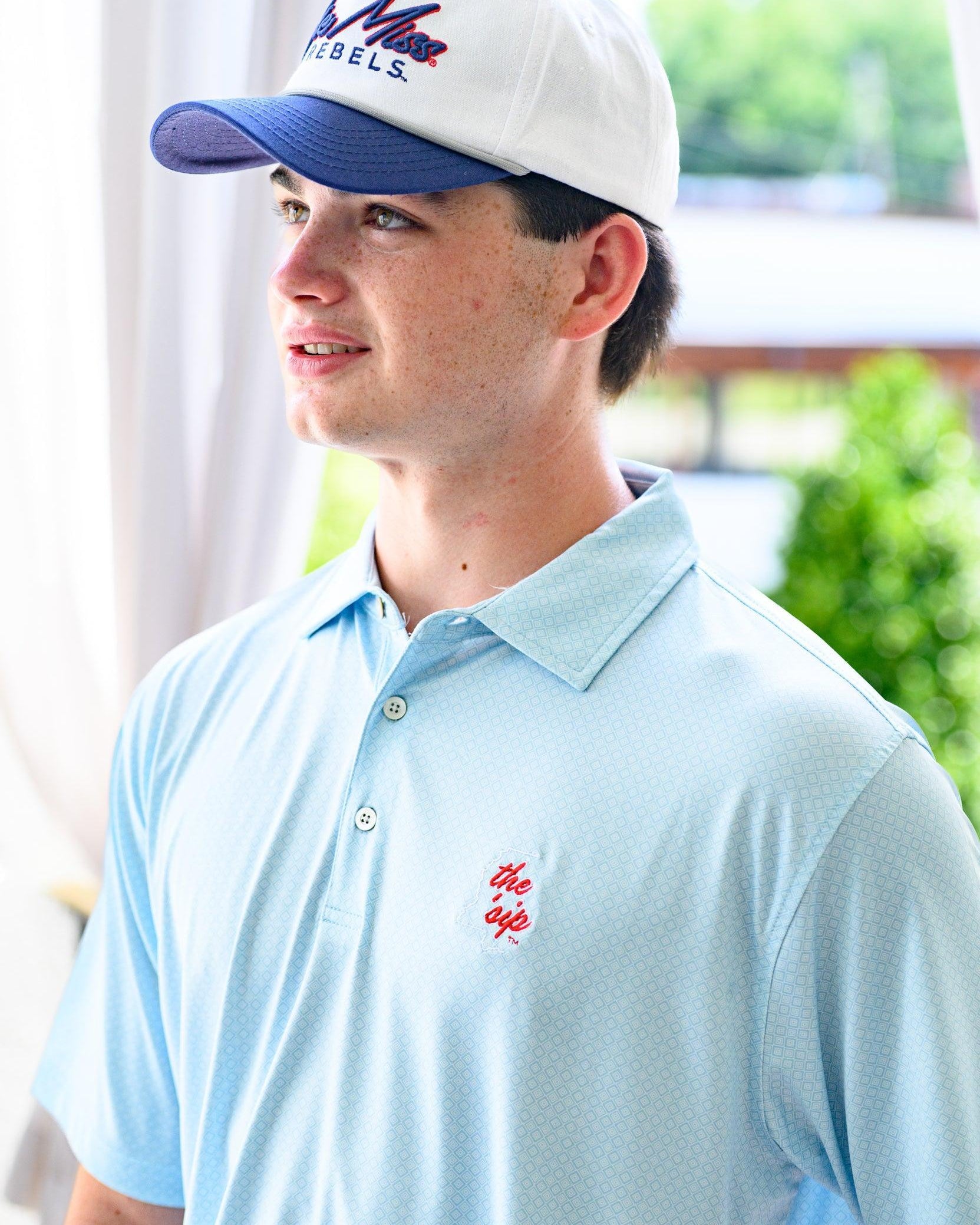Ole Miss Blue Men’s Diamond Polo with an embroidered White outline of Mississippi and Red script “the ‘Sip”