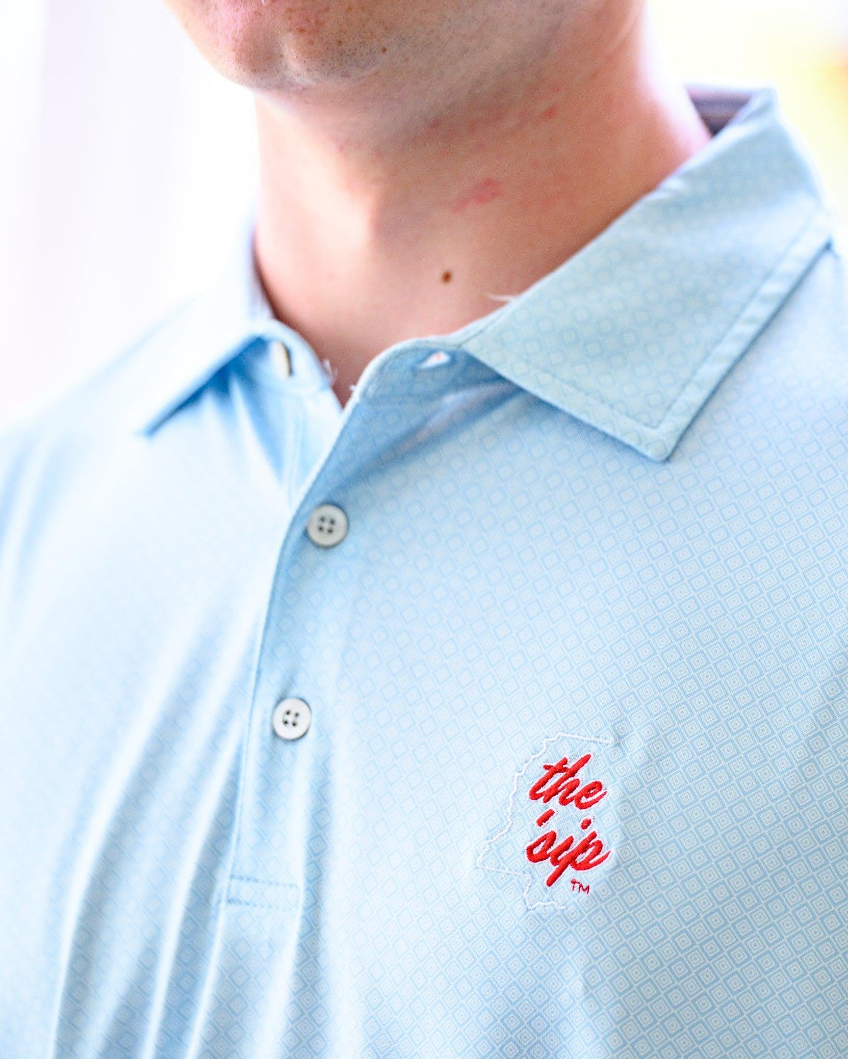Ole Miss Blue Men’s Diamond Polo with an embroidered White outline of Mississippi and Red script “the ‘Sip”