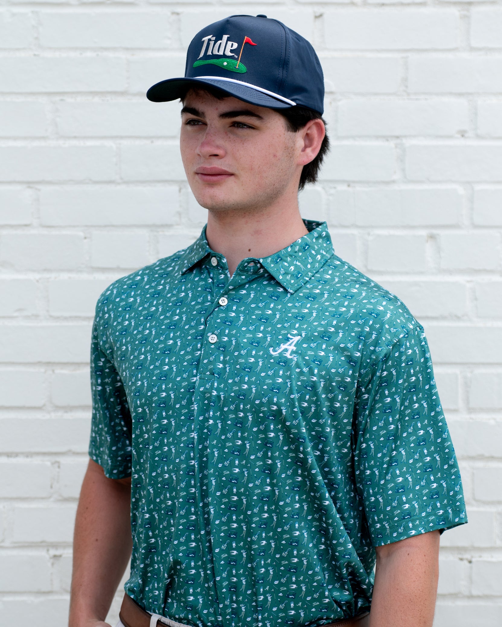 University of Alabama Navy Hat with a White Rope and White text “Tide” above an image of a golf hole