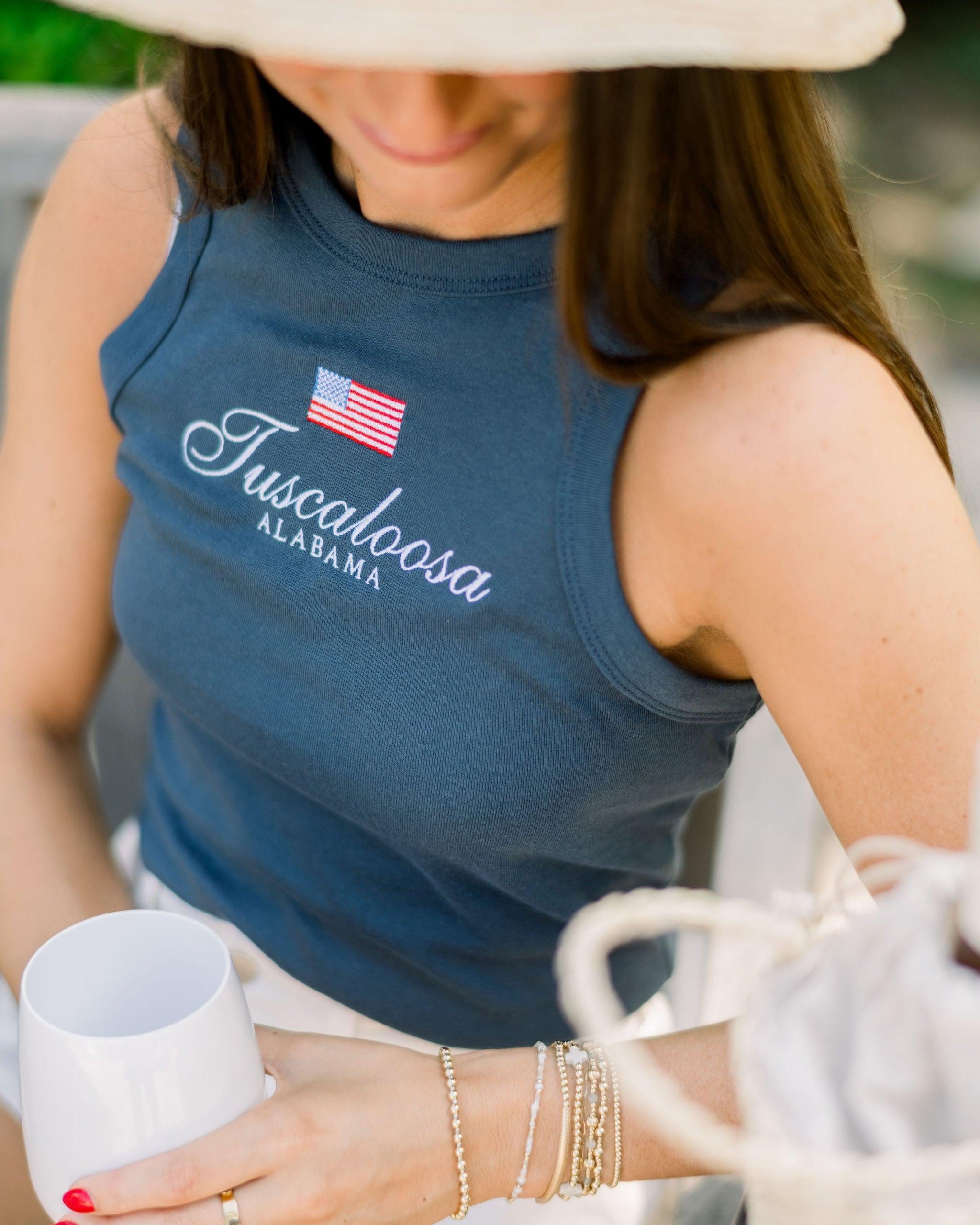 Local Merch Navy Tank Top with an embroidered American Flag above White embroidered text “Tuscaloosa Alabama”