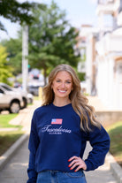 Navy Crewneck with an American Flag above White text “Tuscaloosa Alabama”