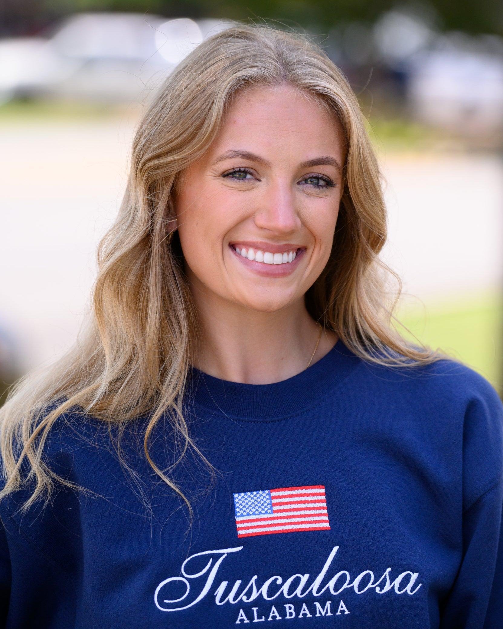 Navy Crewneck with an American Flag above White text “Tuscaloosa Alabama”