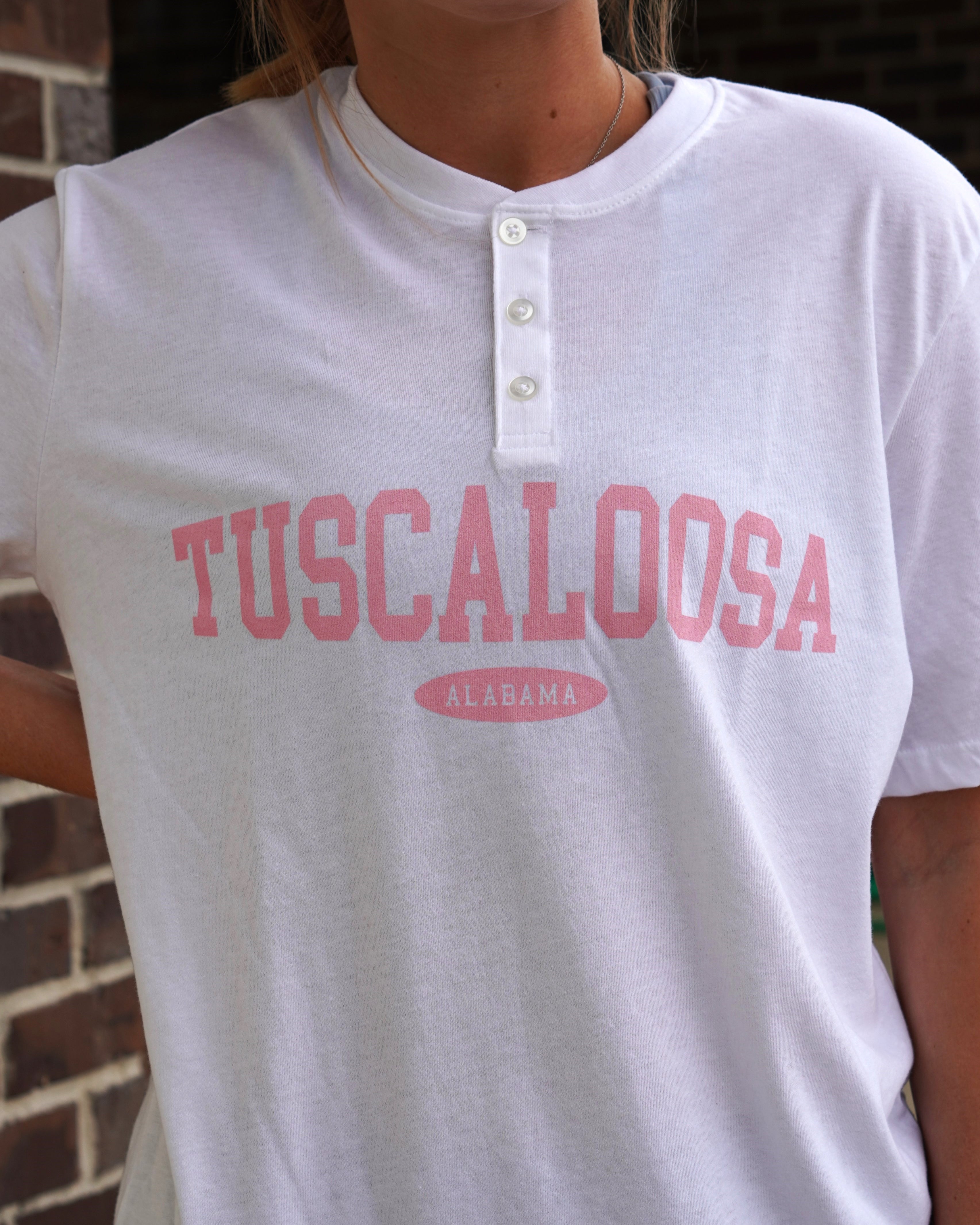 White Tuscaloosa Ladies' Henley with Pink text "Tuscaloosa"