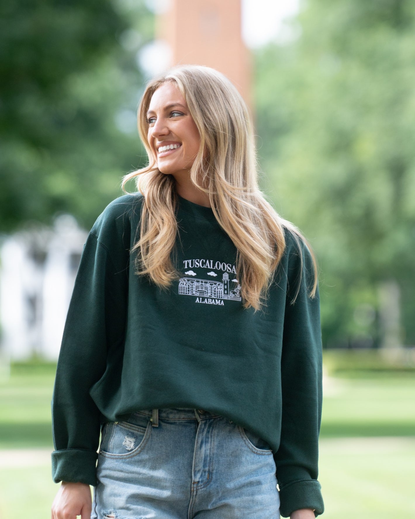University of Alabama Tuscaloosa Landmarks Dark Green Lane Seven Ladies' Sweatshirt with White embroidery of Tuscaloosa landmarks under text "Tuscaloosa"