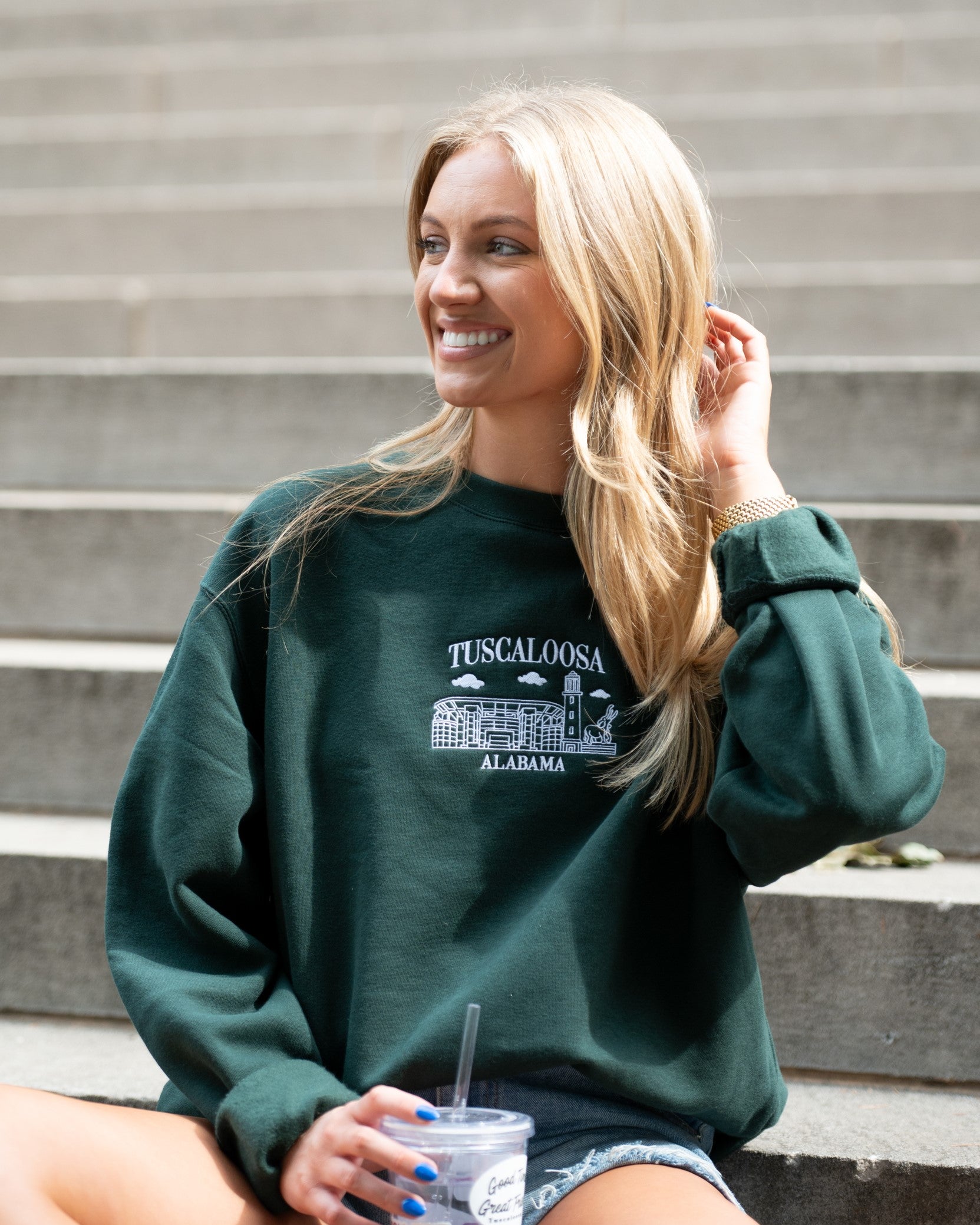 University of Alabama Tuscaloosa Landmarks Dark Green Lane Seven Ladies' Sweatshirt with White embroidery of Tuscaloosa landmarks under text "Tuscaloosa"