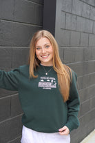 University of Alabama Tuscaloosa Landmarks Dark Green Lane Seven Ladies' Sweatshirt with White embroidery of Tuscaloosa landmarks under text "Tuscaloosa"
