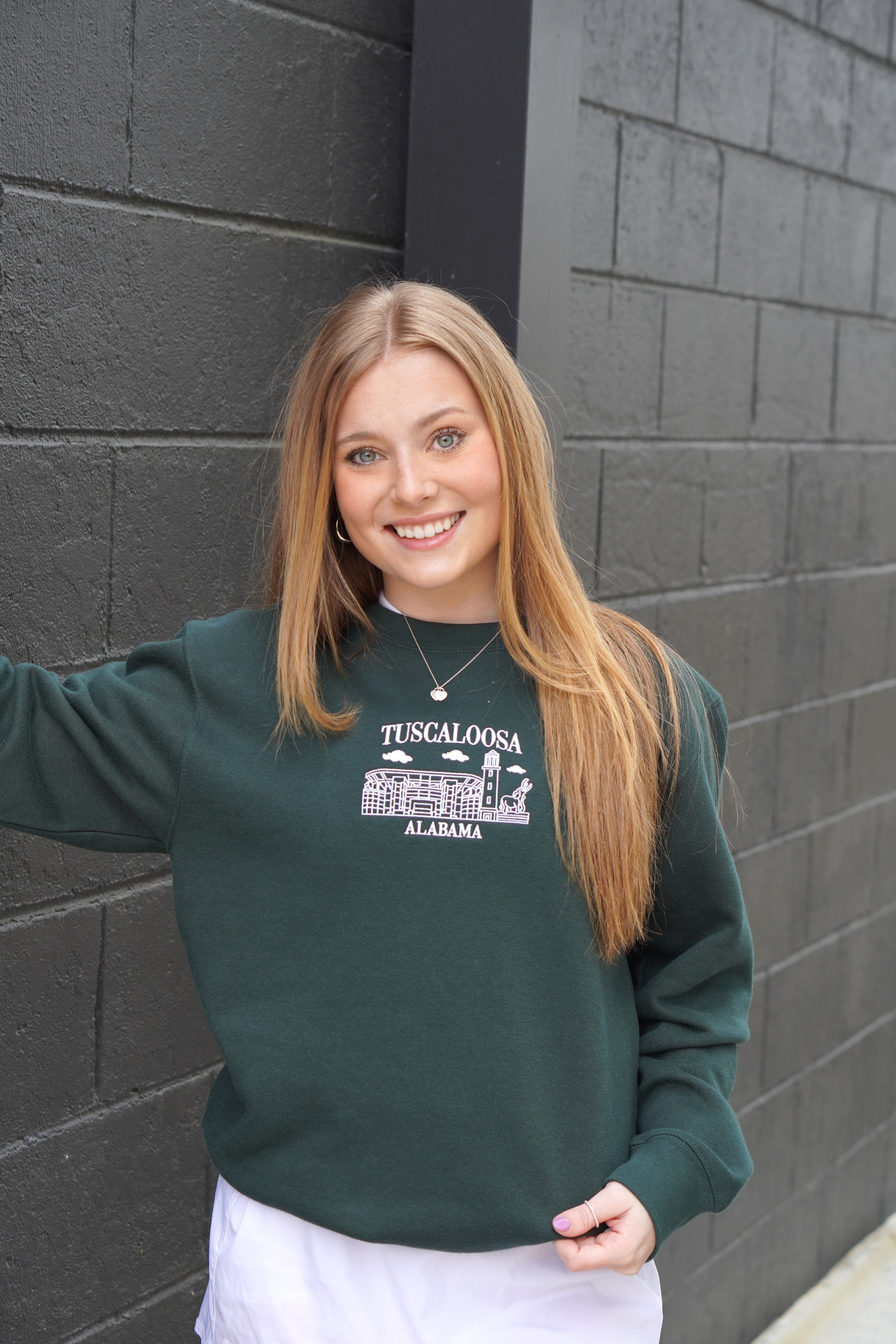 University of Alabama Tuscaloosa Landmarks Dark Green Lane Seven Ladies' Sweatshirt with White embroidery of Tuscaloosa landmarks under text "Tuscaloosa"