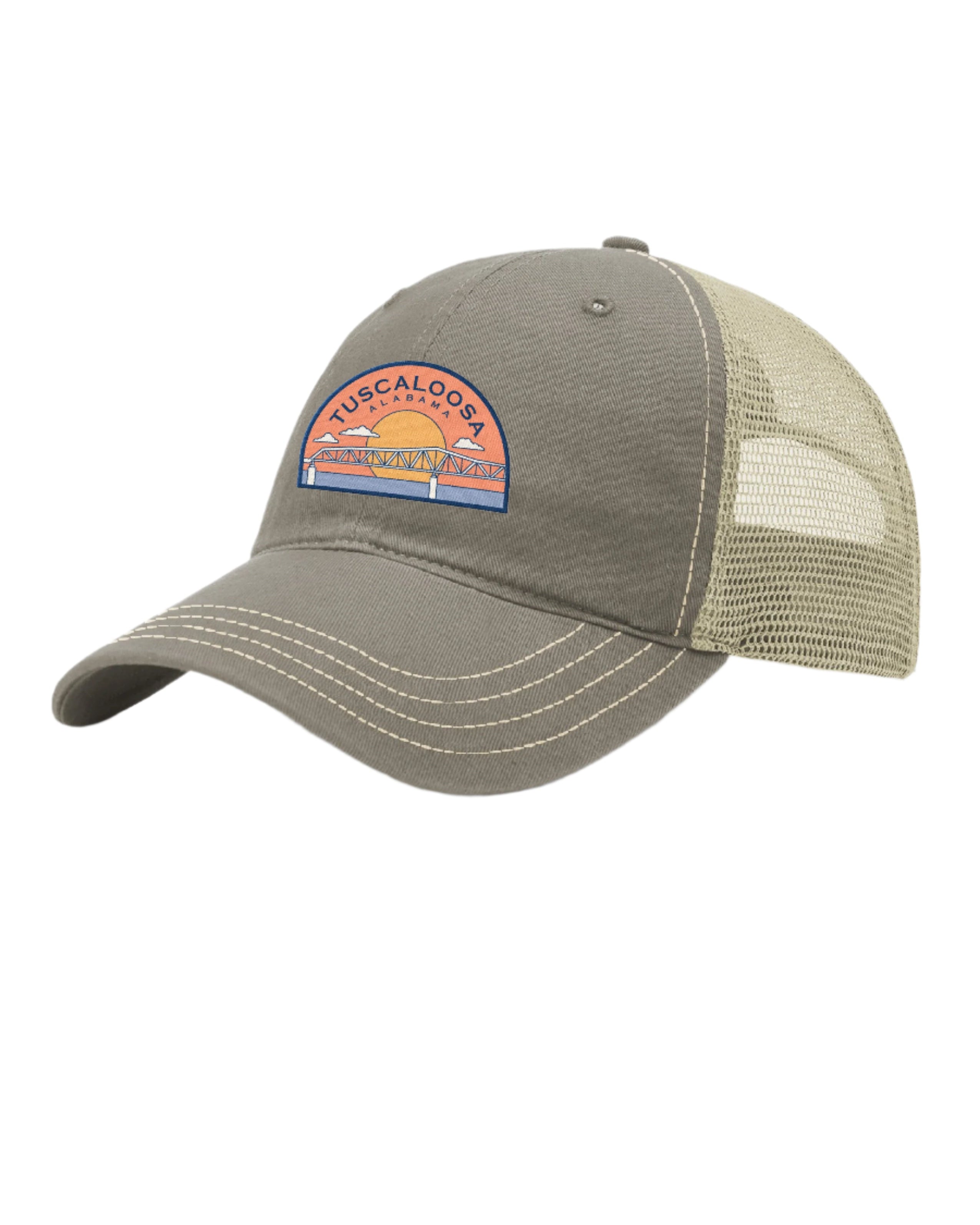 Tuscaloosa Beige Trucker Hat with a patch featuring Blue text "Tuscaloosa Alabama" a drawing of the sun setting on the iconic Tuscaloosa Trestle