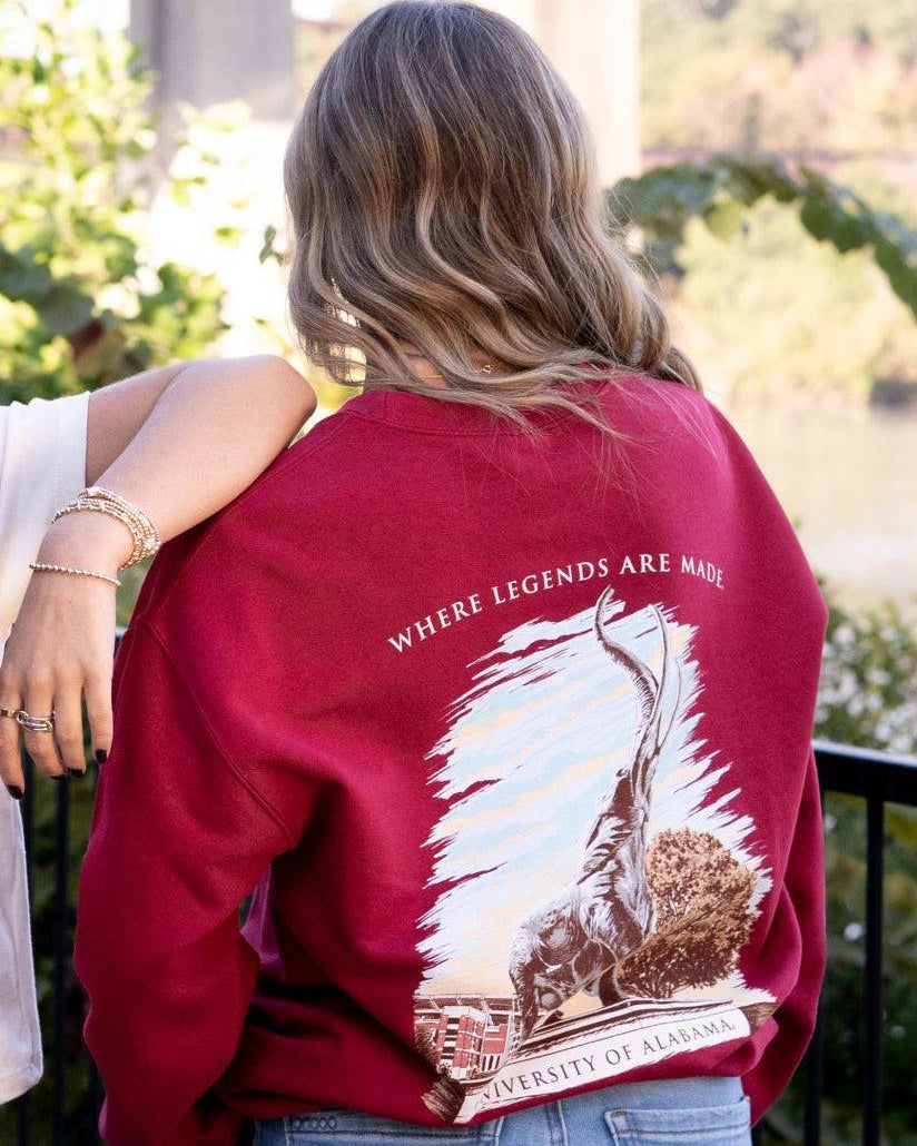 University of Alabama Red Sweatshirt with an image of the Tuska Statue underneath White text "Where Legends Are Made"