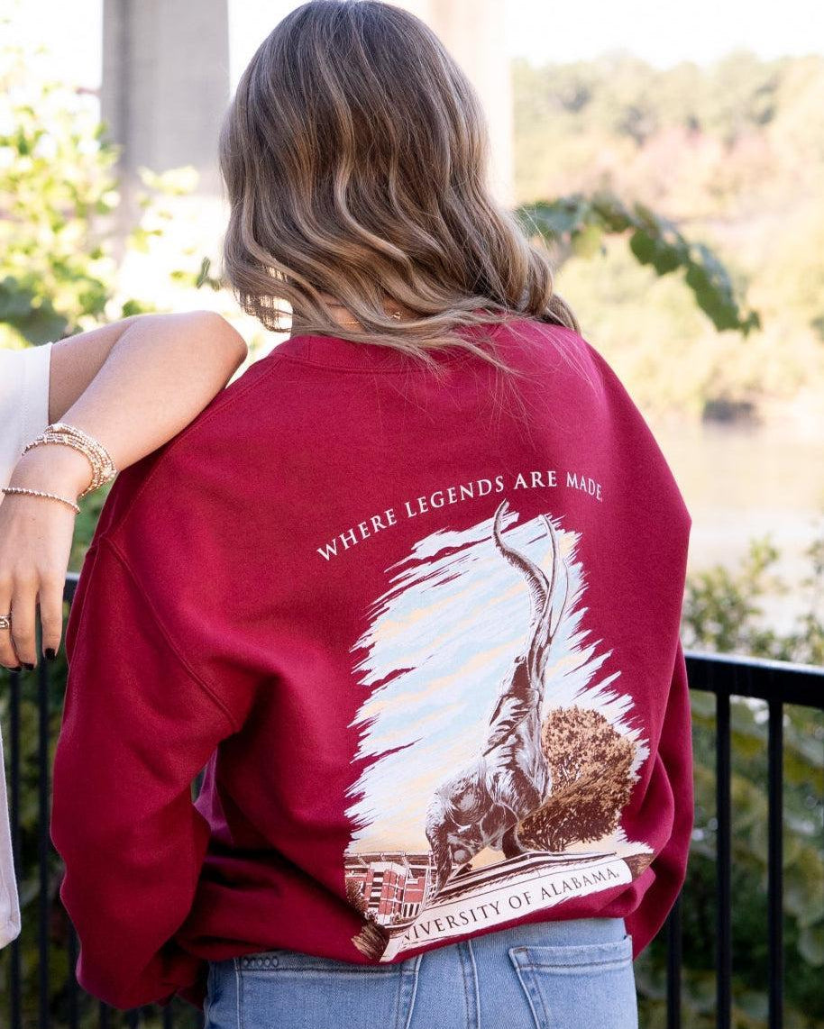 University of Alabama Red Sweatshirt with an image of the Tuska Statue underneath White text "Where Legends Are Made"