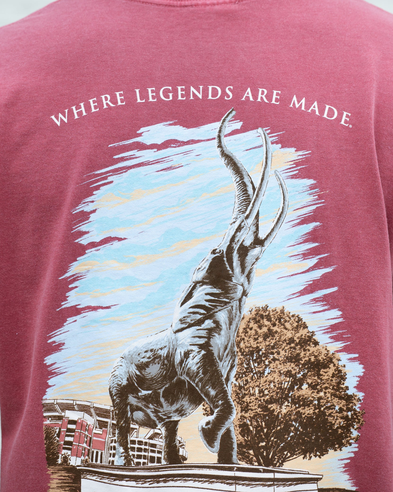 University of Alabama Red T-Shirt with an image of the Tuska Statue underneath White text "Where Legends Are Made"