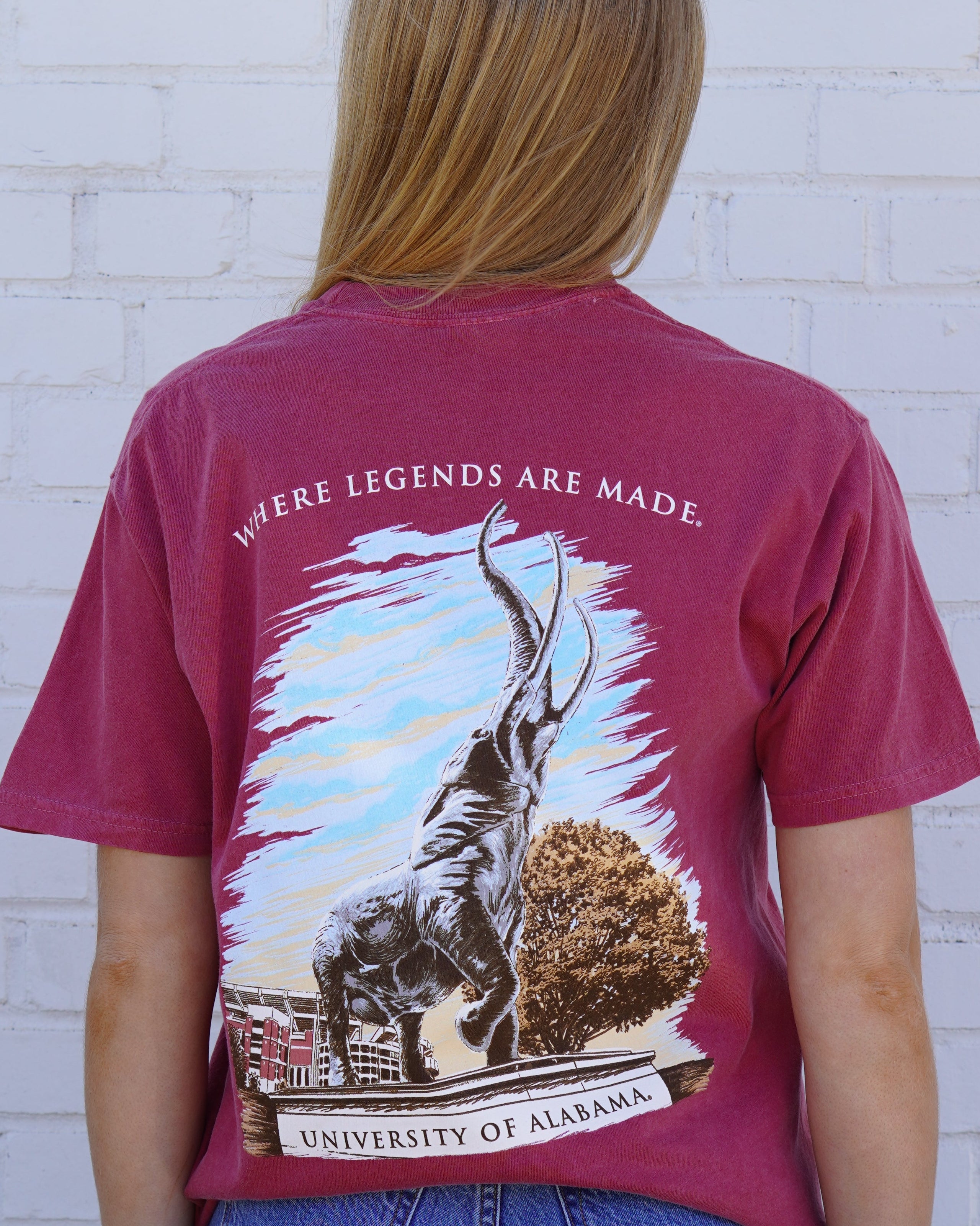 University of Alabama Red T-Shirt with an image of the Tuska Statue underneath White text "Where Legends Are Made"