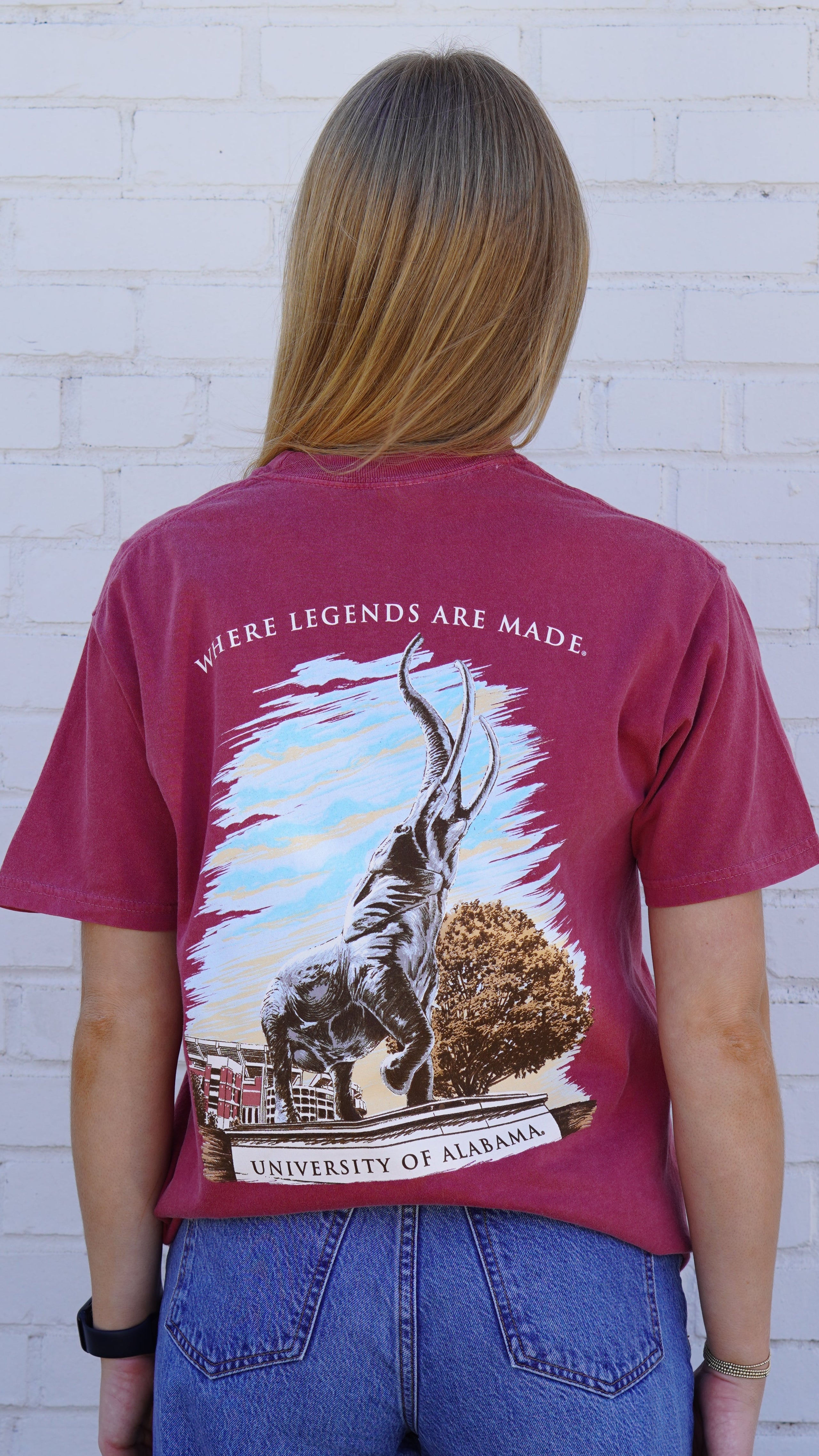 University of Alabama Red T-Shirt with an image of the Tuska Statue underneath White text "Where Legends Are Made"