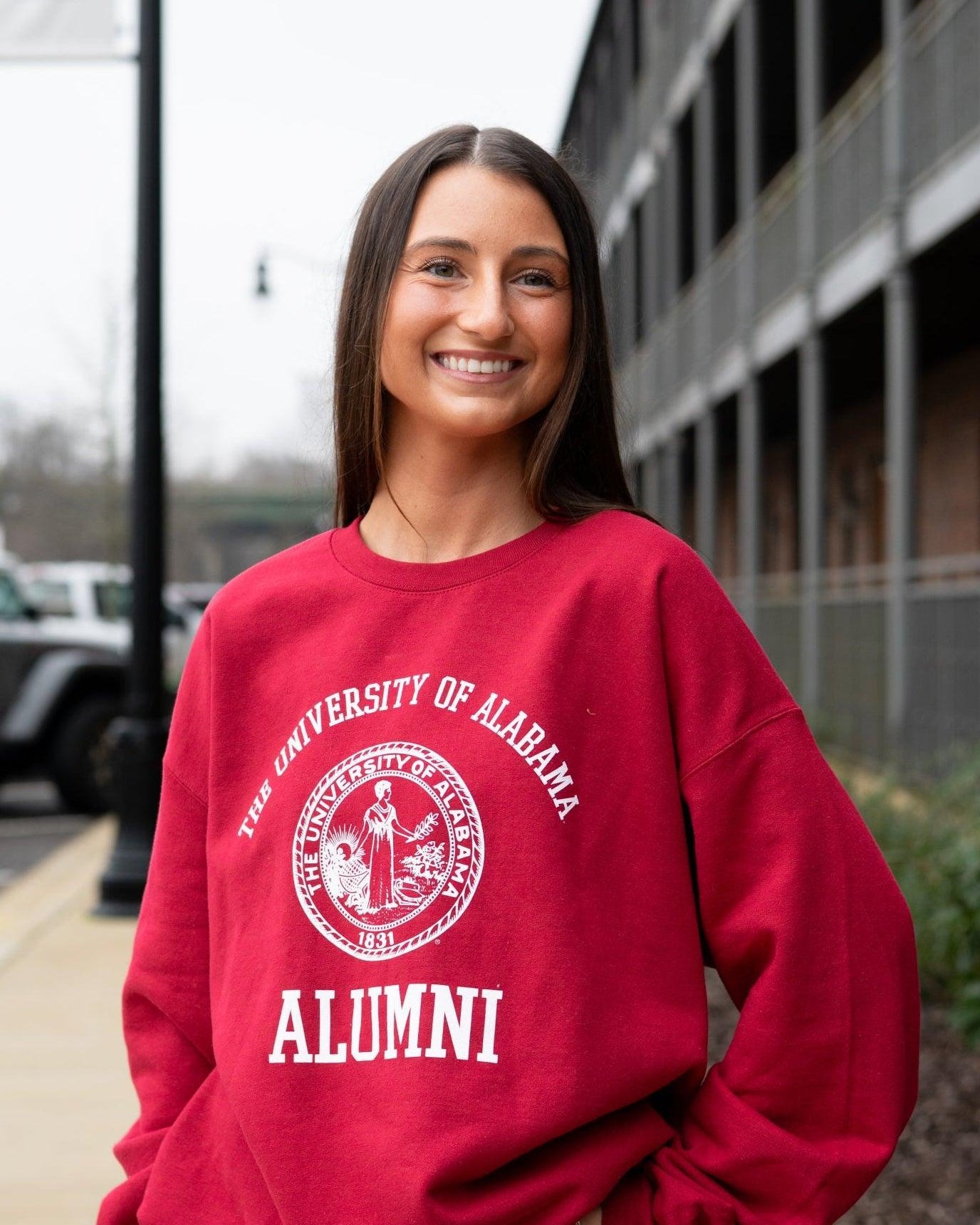 University of Alabama Red Alumni Sweatshirt with White text "University of Alabama" above the White Alumni Seal and White text "Alumni" below