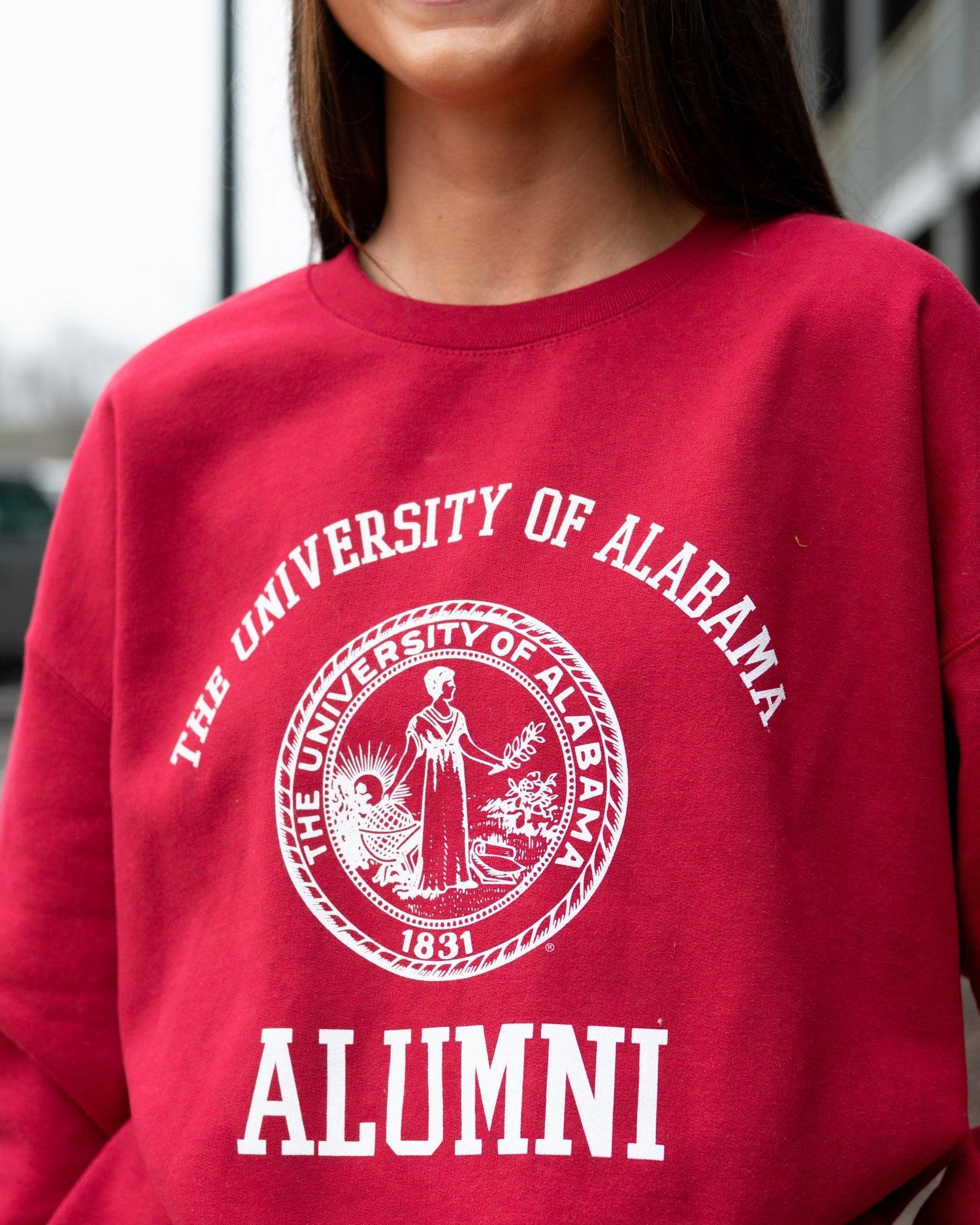 University of Alabama Red/Light Grey Alumni Sweatshirt with White text "University of Alabama" above the White Alumni Seal and White text "Alumni" below