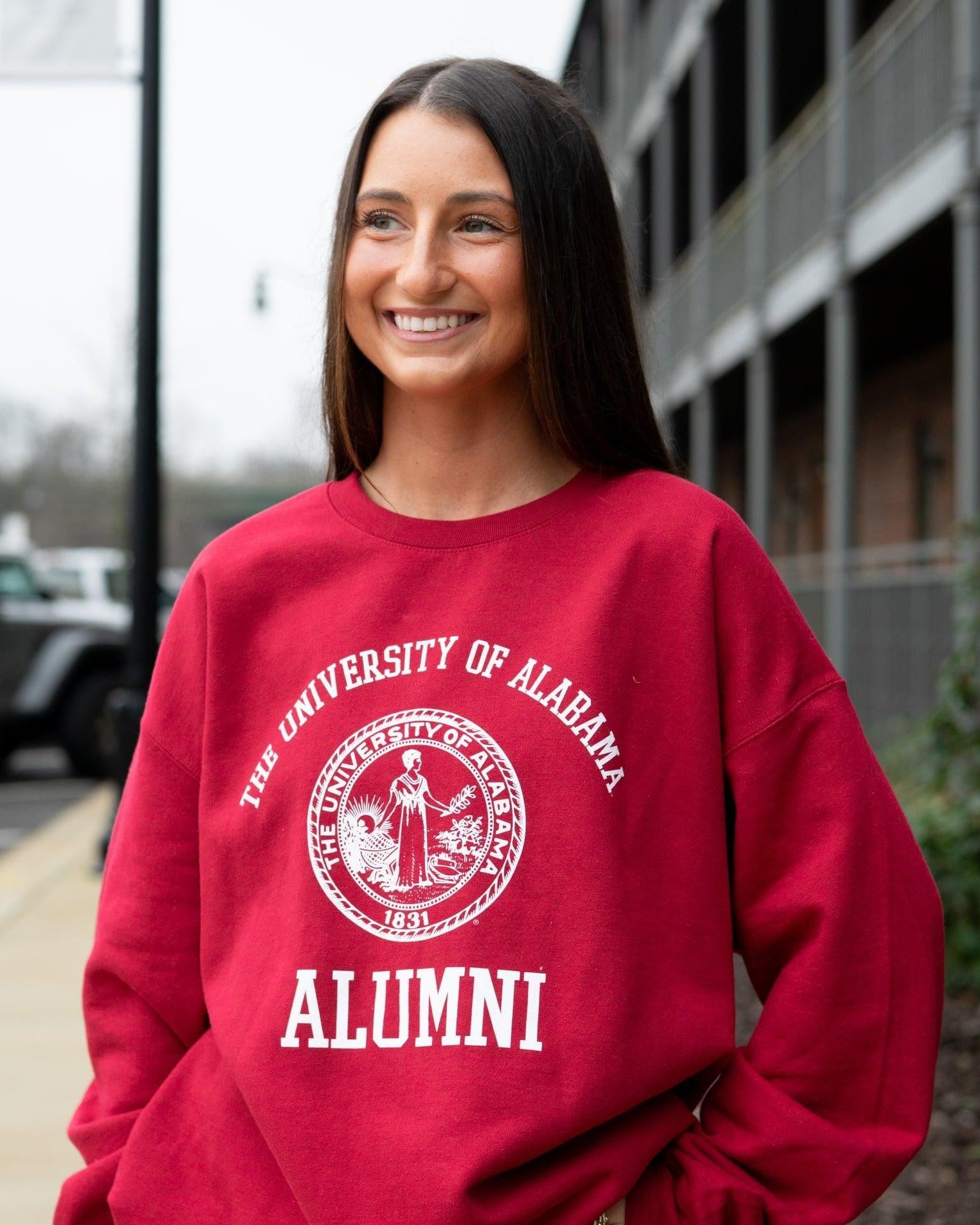 University of Alabama Red Alumni Sweatshirt with White text "University of Alabama" above the White Alumni Seal and White text "Alumni" below