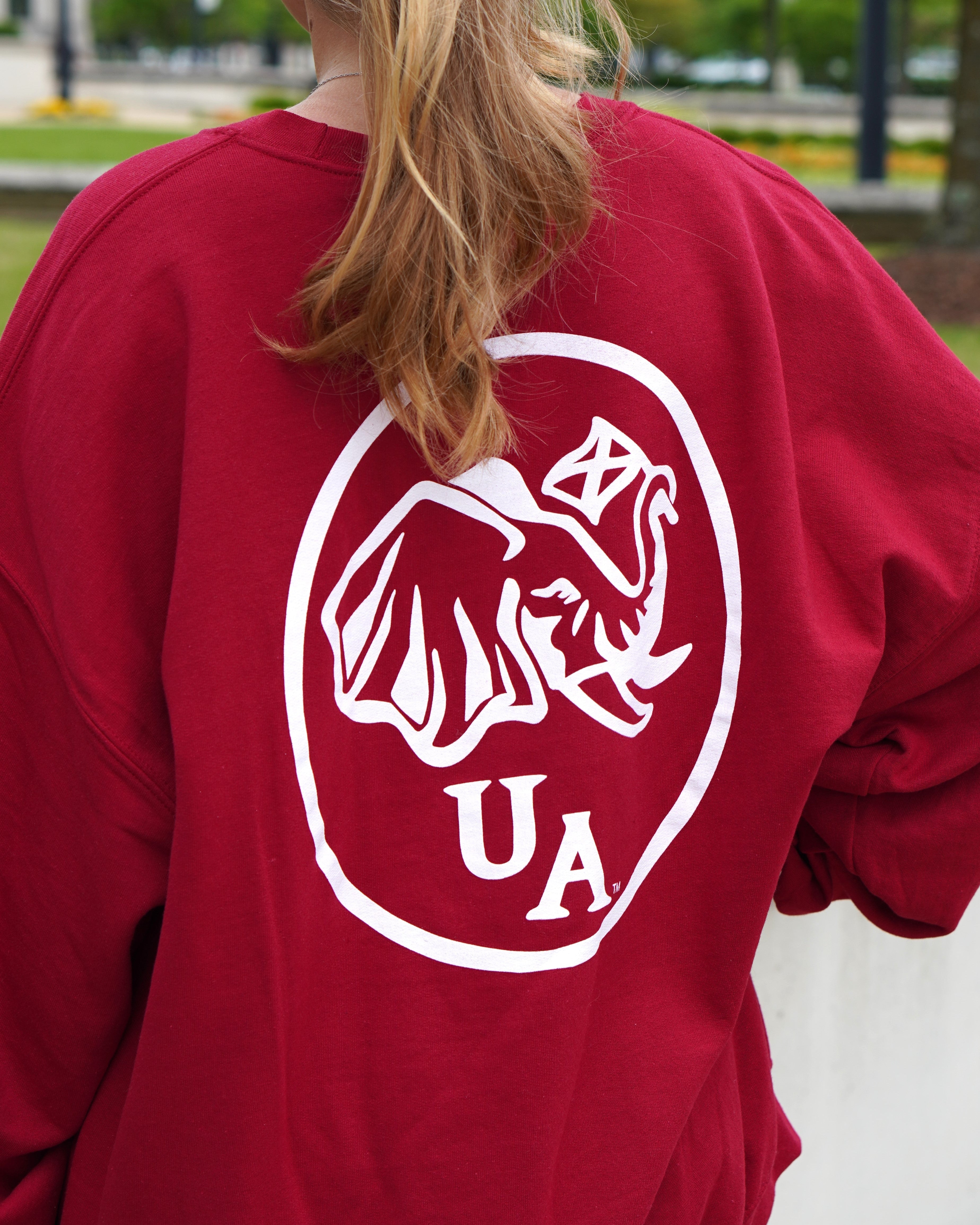 University of Alabama Red Elephant Seal Sweatshirt with an image of an elephant holding an Alabama State flag above he letters "UA"
