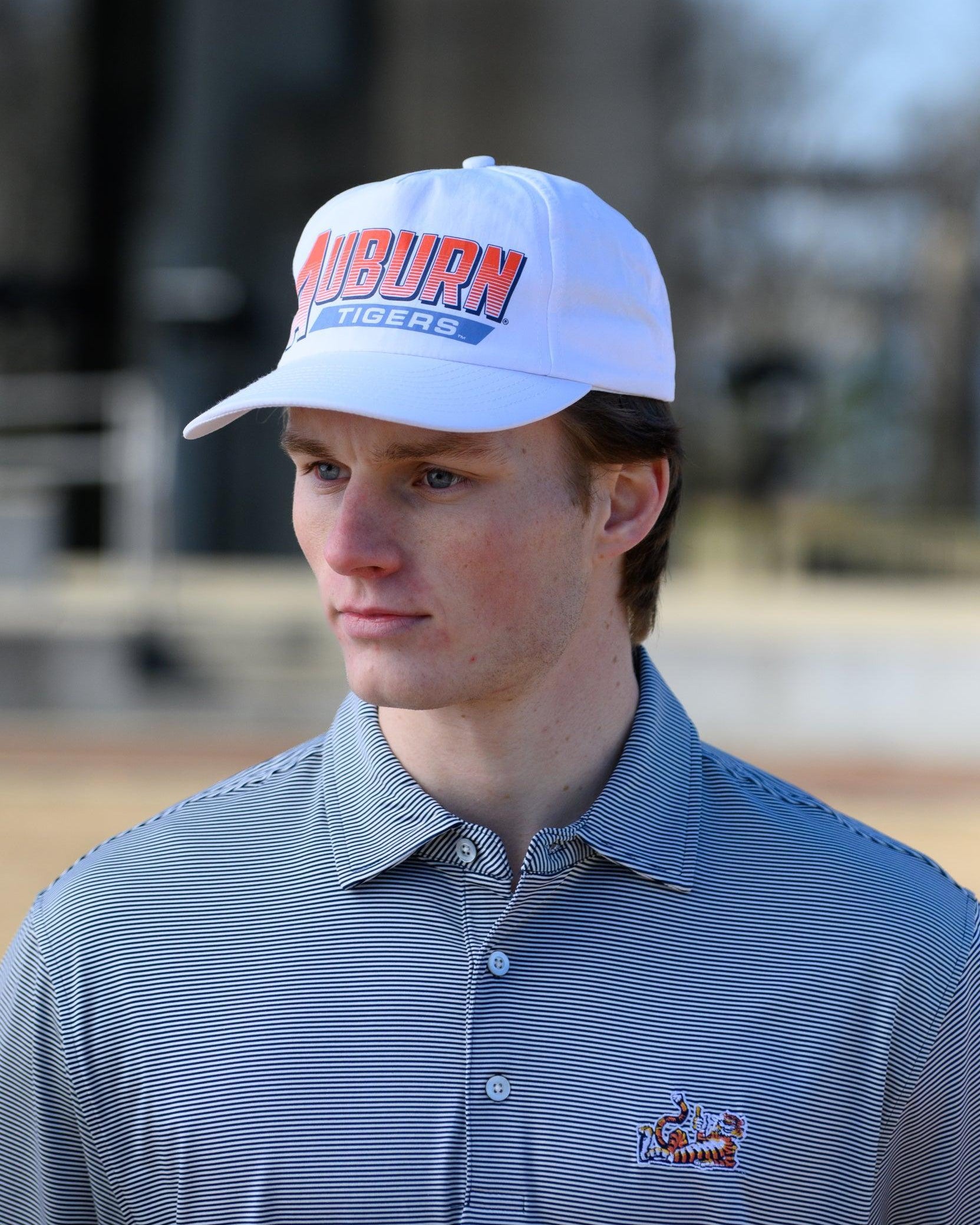 Auburn University White Hat with Orange text "Auburn" above a Blue Stripe with White text "Tigers"