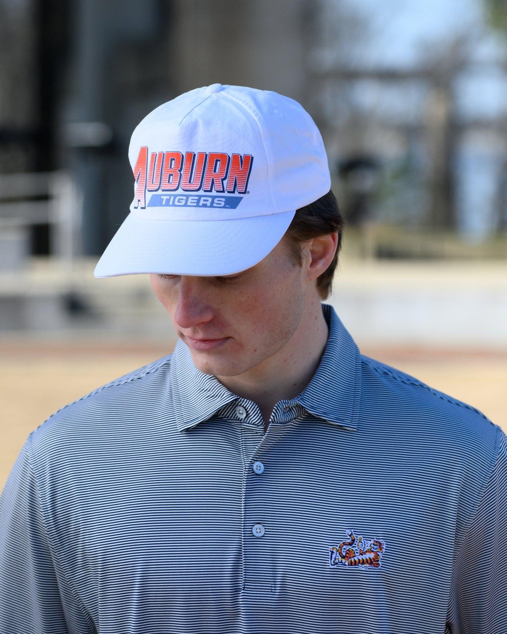 Auburn University White Hat with Orange text "Auburn" above a Blue Stripe with White text "Tigers"