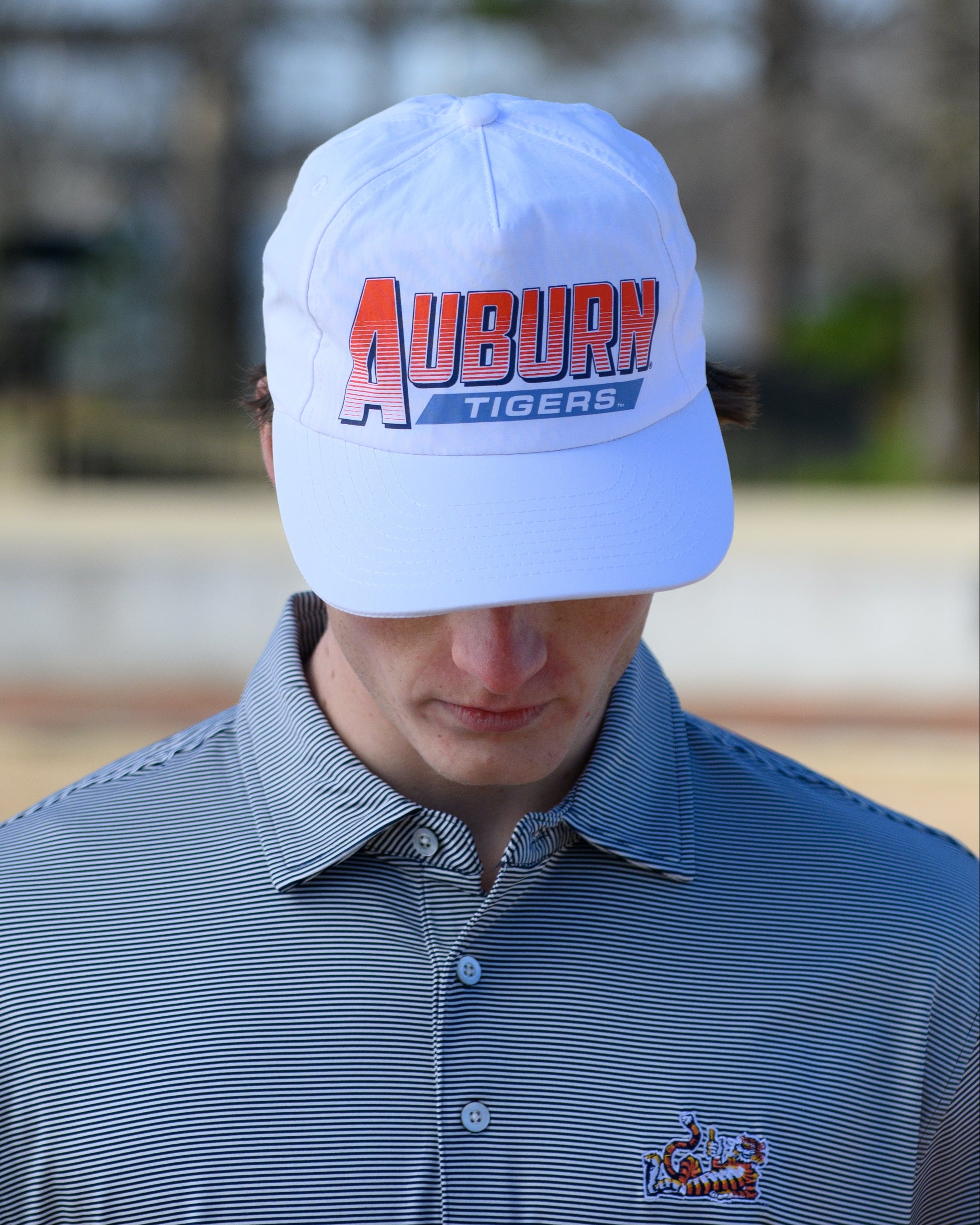 Auburn University White Hat with Orange text "Auburn" above a Blue Stripe with White text "Tigers"