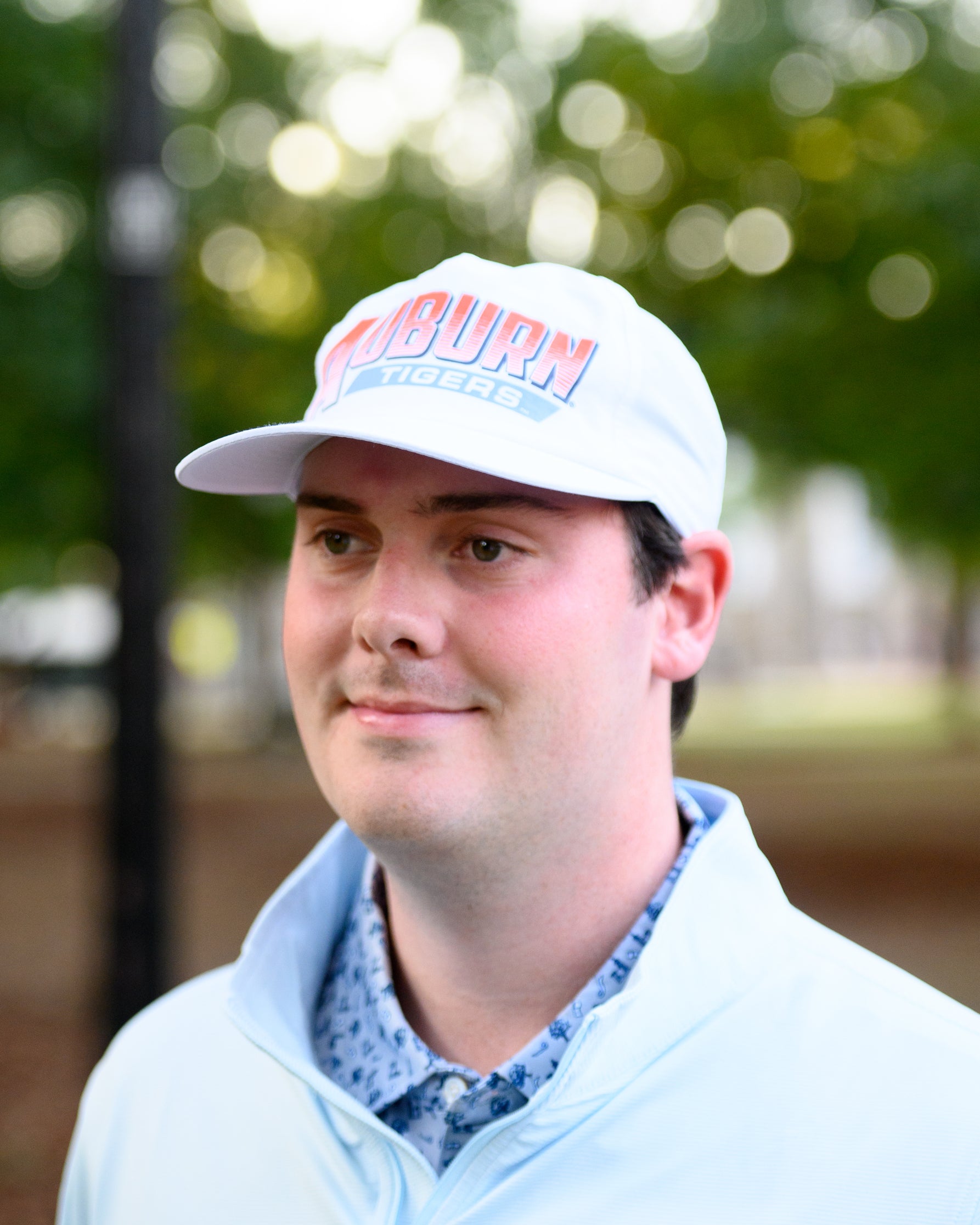 Auburn University White Hat with Orange text "Auburn" above a Blue Stripe with White text "Tigers"