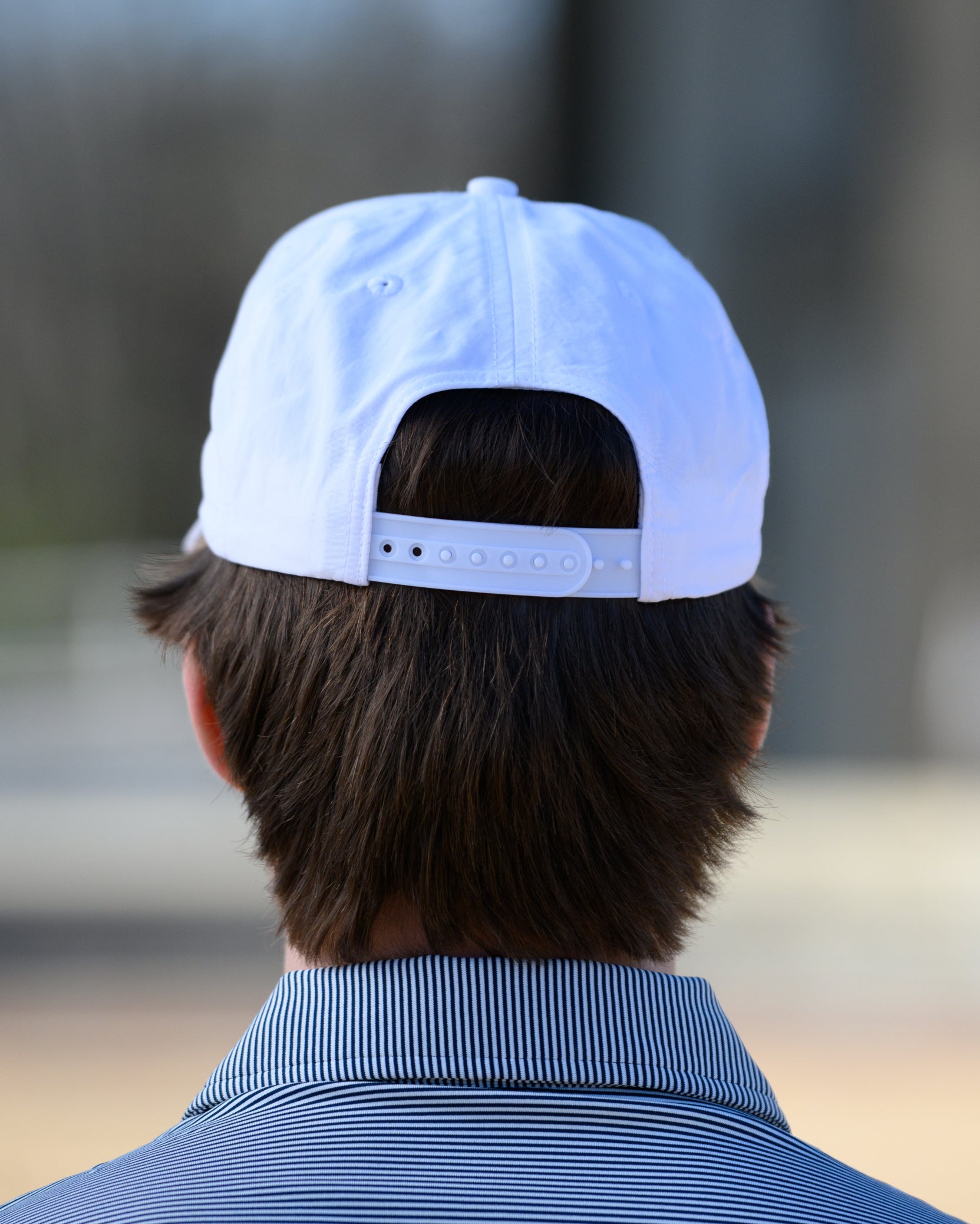 Auburn University White Hat with Orange text "Auburn" above a Blue Stripe with White text "Tigers."
Snapback Hat