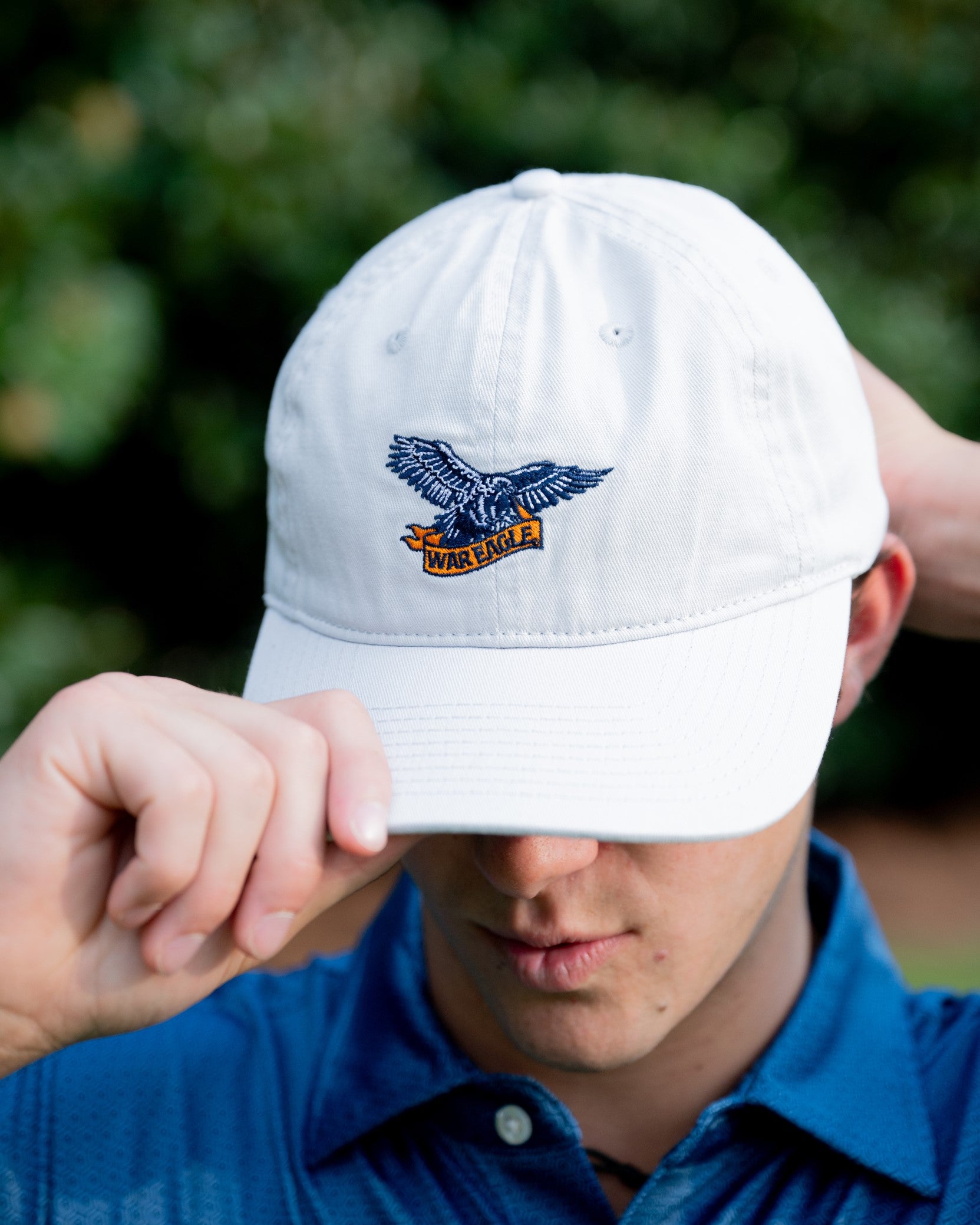 Auburn University White Dad Hat with a blue embroidered logo of the War Eagle Banner.