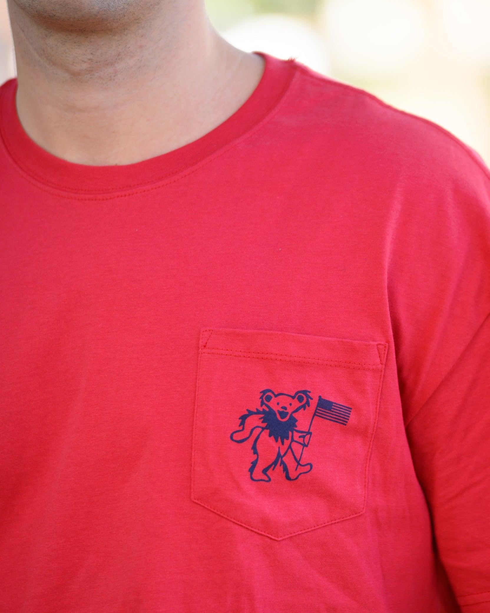 Grateful State Red T-Shirt with a front pocket design featuring a dancing bear holding a flag