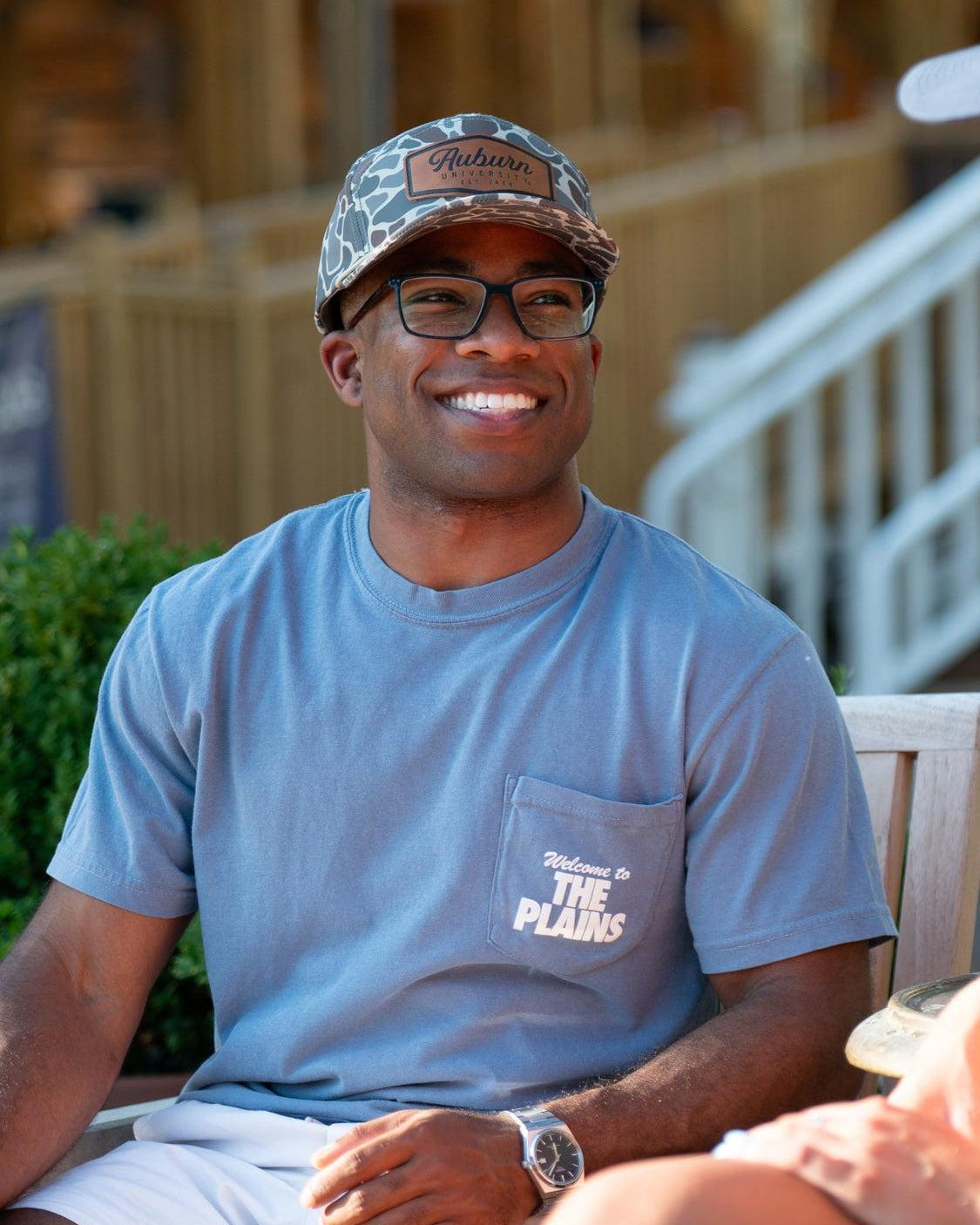 Auburn University Blue The Plains T-Shirt with postcard style text "Welcome to THE PLAINS" with "The Plains" filled with images of iconic buildings in that location